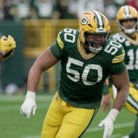 Green Bay Packers offensive tackle Zach Tom (50) leads a running back during the third quarter of their game against the Minnesota Vikings Sunday, November 23, 2025 at Lambeau Field in Green Bay, Wisconsin.