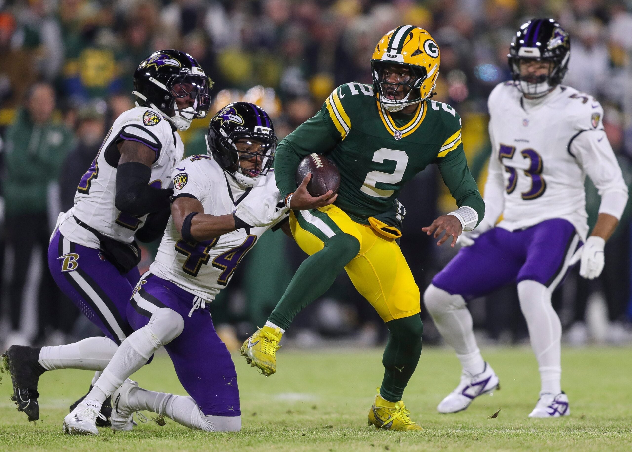 Green Bay Packers quarterback Malik Willis (2) spins out of a tackle by Baltimore Ravens cornerback Marlon Humphrey (44) on Saturday, December 27, 2025, at Lambeau Field in Green Bay, Wis. The Ravens won the game, 41-24.