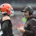 Dec 28, 2025; Cleveland, Ohio, USA; Cleveland Browns head coach Kevin Stefanski speaks with quarterback Shedeur Sanders (12) during a time out in the second quarter against the Pittsburgh Steelers at Huntington Bank Field. Mandatory Credit: Scott Galvin-Imagn Images