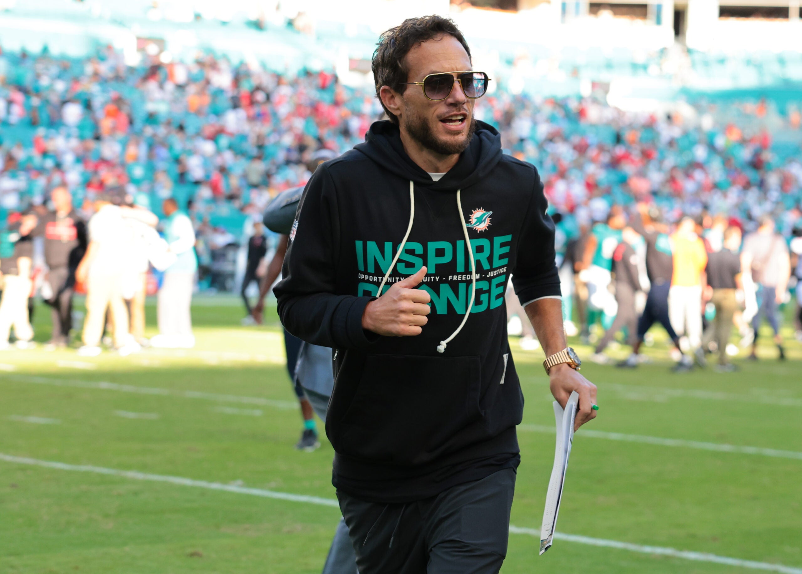 Dec 28, 2025; Miami Gardens, Florida, USA; Miami Dolphins head coach Mike McDaniel runs off the field following a win over the Tampa Bay Buccaneers at Hard Rock Stadium.