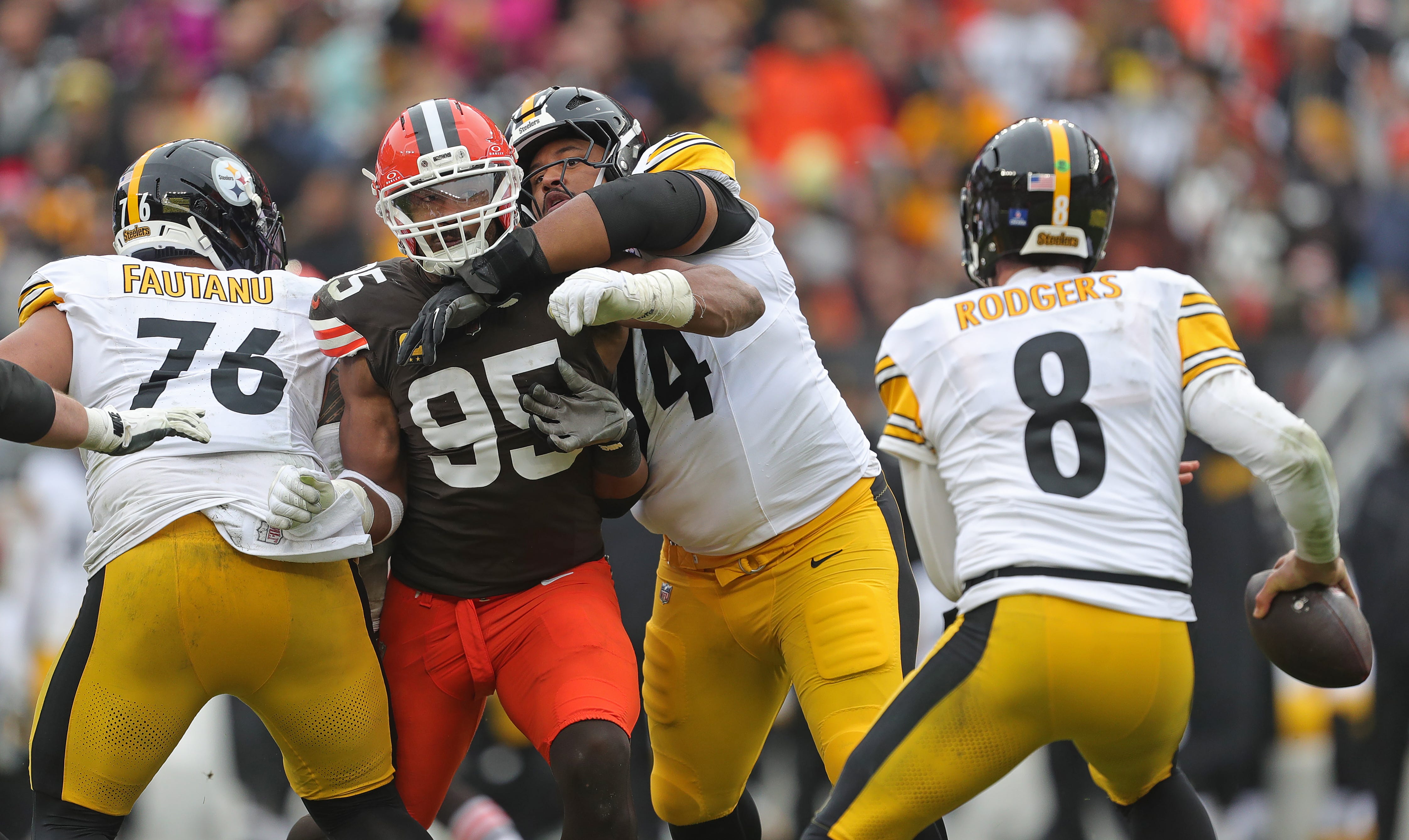 Cleveland Browns defensive end Myles Garrett (95) tries to get past Pittsburgh Steelers offensive tackle Troy Fautanu (76) and guard Spencer Anderson (74) during the second half of an NFL football game at Huntington Bank Field, Dec. 28, 2025, in Cleveland, Ohio.