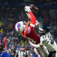 Dec 28, 2025; Orchard Park, New York, USA; Buffalo Bills wide receiver Tyrell Shavers (14) leaps to catch a thirty-two yard pass thrown by quarterback Josh Allen (not pictured) against Philadelphia Eagles cornerback Quinyon Mitchell (27) during the third quarter at Highmark Stadium.