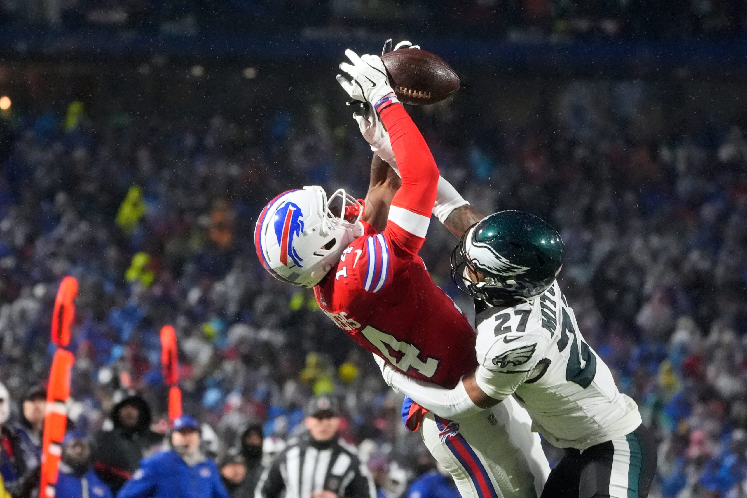 Dec 28, 2025; Orchard Park, New York, USA; Buffalo Bills wide receiver Tyrell Shavers (14) leaps to catch a thirty-two yard pass thrown by quarterback Josh Allen (not pictured) against Philadelphia Eagles cornerback Quinyon Mitchell (27) during the third quarter at Highmark Stadium.