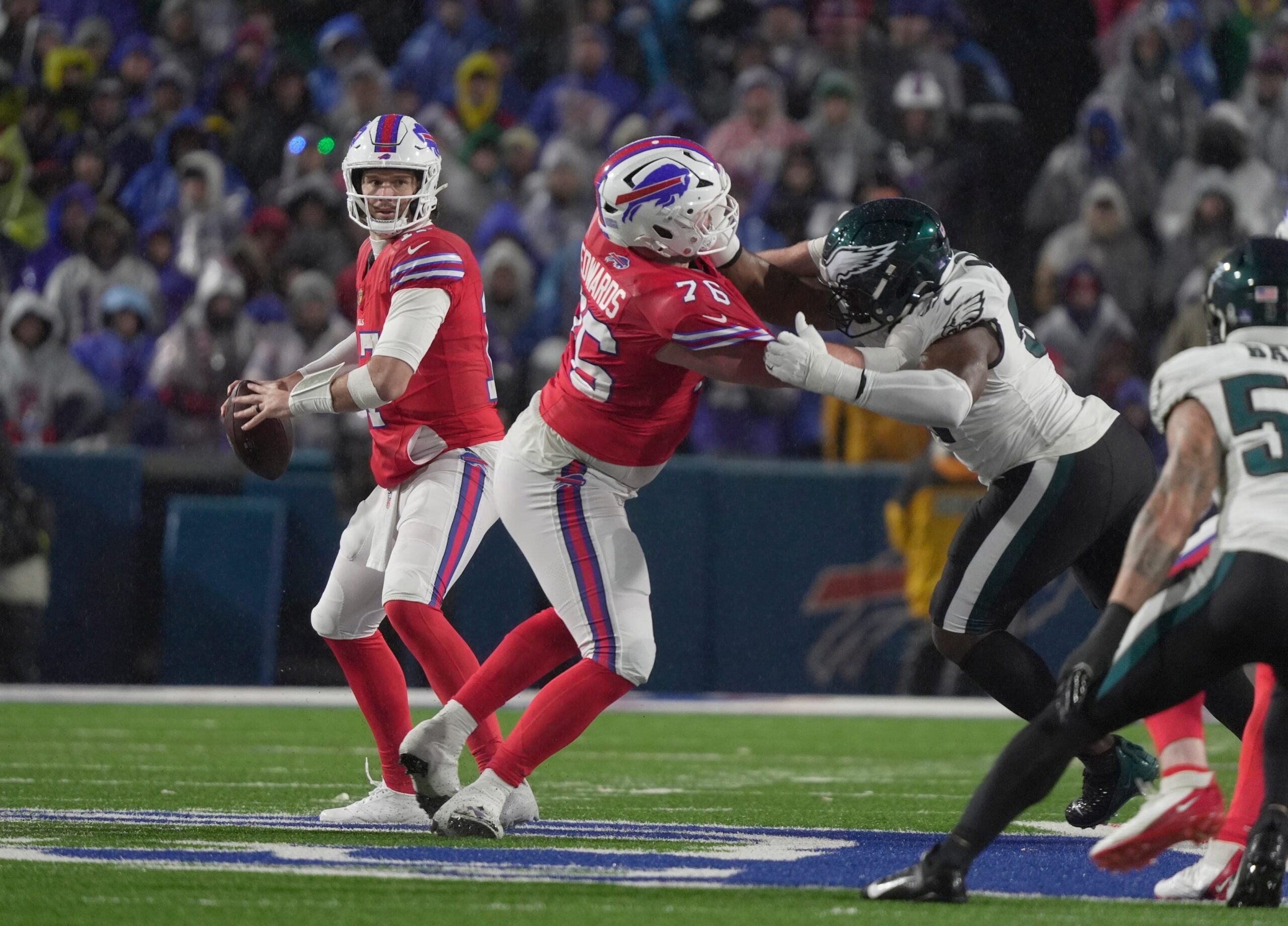 Buffalo Bills quarterback Josh Allen looks for an open receiver during second half action against the Philadelphia Eagles at Highmark Stadium in Orchard Park on Dec. 28, 2025. He ends up gettig sacked by an Eagles player who came running up the left side.