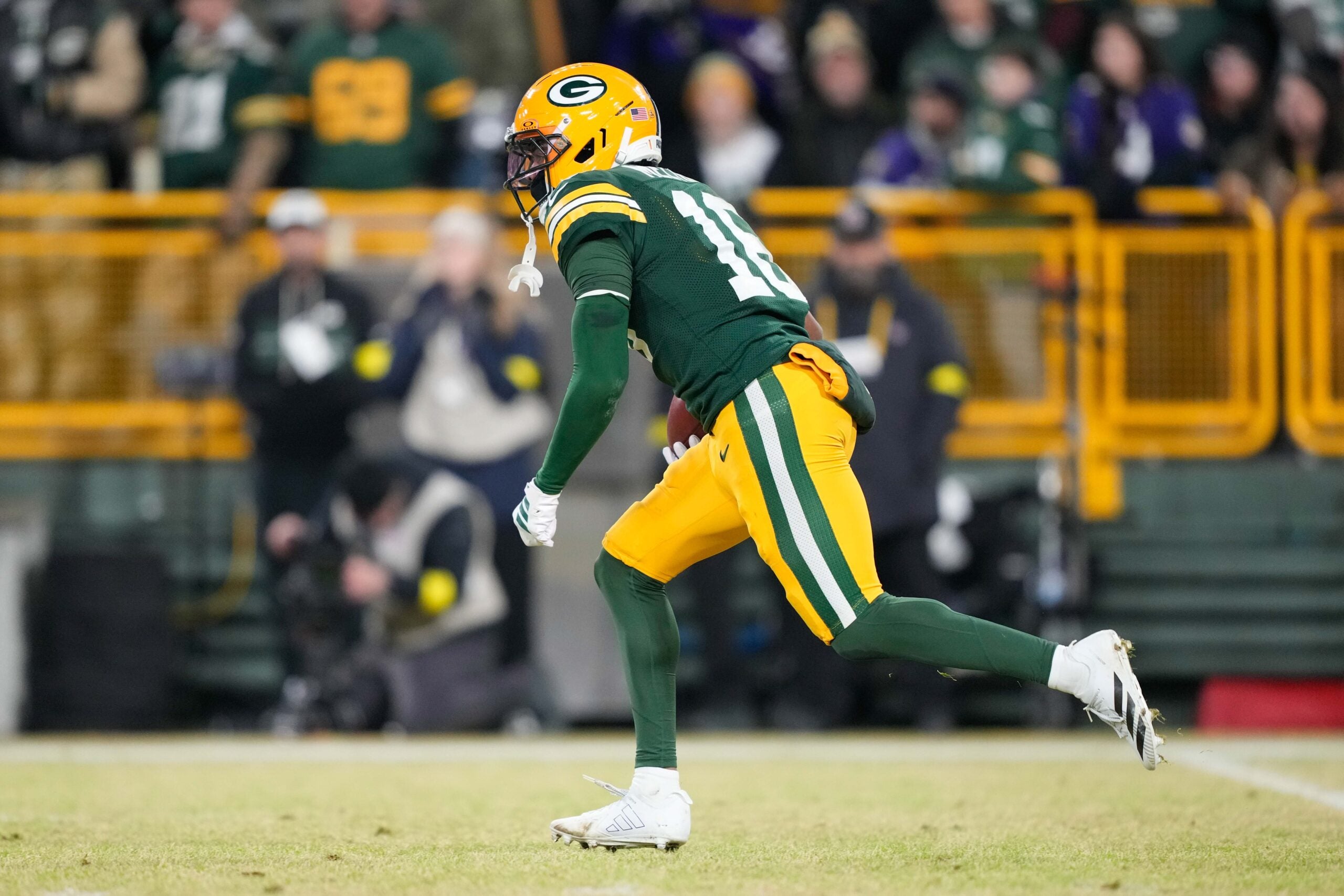 Dec 27, 2025; Green Bay, Wisconsin, USA; Green Bay Packers cornerback Bo Melton (16) runs the ball on a kickoff return during the fourth quarter against the Baltimore Ravens at Lambeau Field.