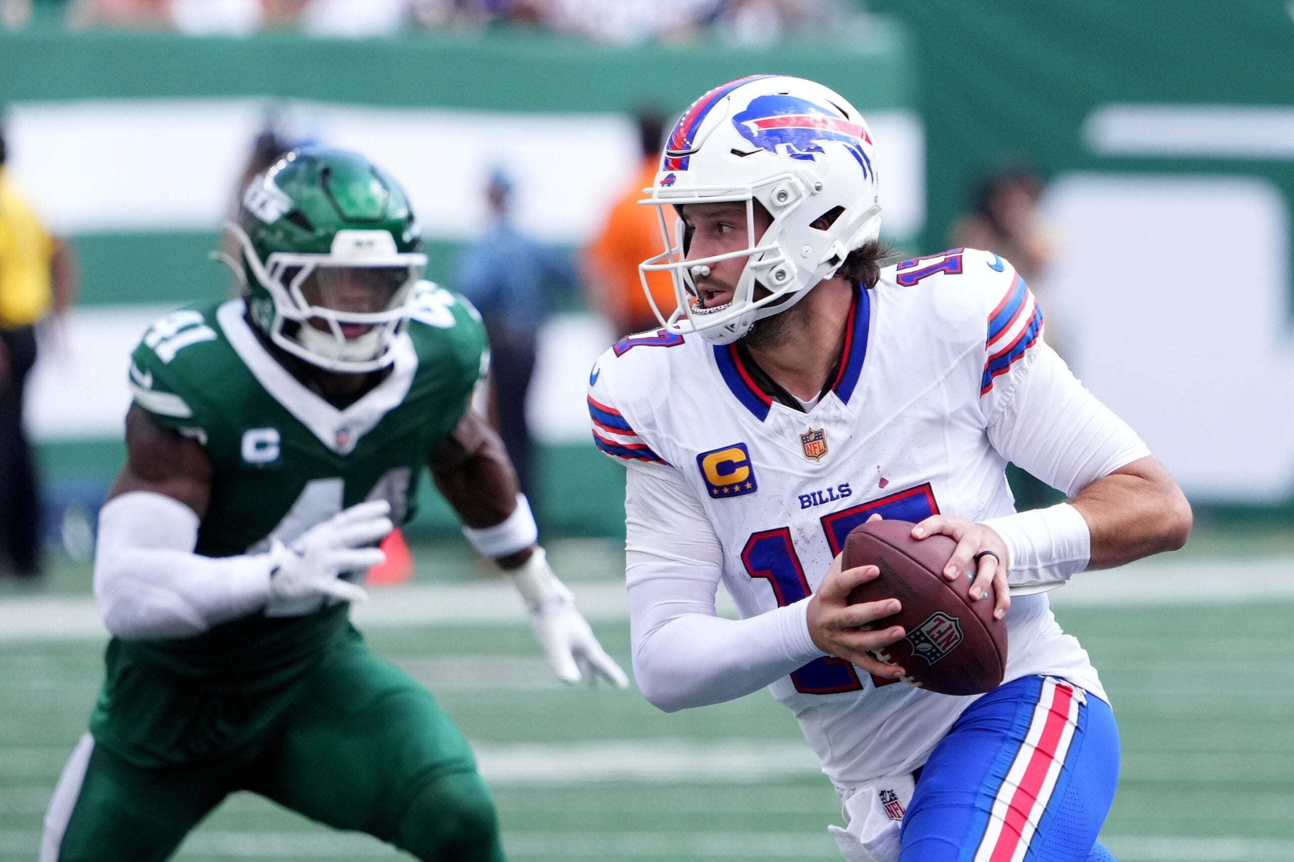Sep 14, 2025; East Rutherford, New Jersey, USA; Buffalo Bills quarterback Josh Allen (17) rushes the ball past New York Jets linebacker Marcelino McCrary-Ball (41) during the first half at MetLife Stadium.