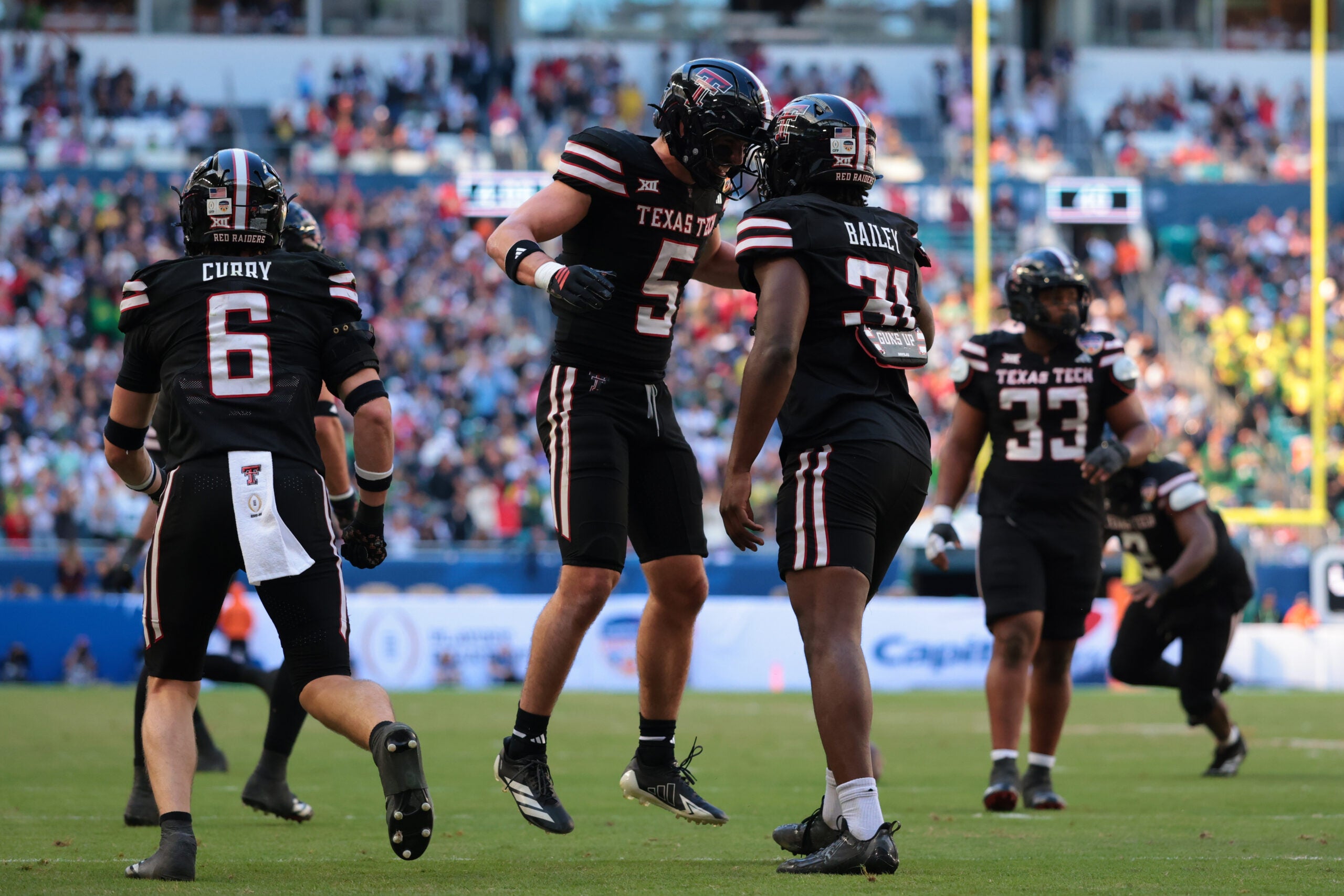 Jan 1, 2026; Miami Gardens, FL, USA; Texas Tech Red Raiders defensive back Cole Wisniewski (5) and linebacker David Bailey (31) react after a defensive play against the Oregon Ducks during the first half of the 2025 Orange Bowl and quarterfinal game of the College Football Playoff at Hard Rock Stadium.