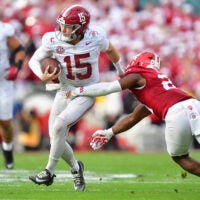 Jan 1, 2026; Pasadena, CA, USA; Alabama Crimson Tide quarterback Ty Simpson (15) runs against Indiana Hoosiers linebacker Rolijah Hardy (21) in the first half of the 2026 Rose Bowl and quarterfinal game of the College Football Playoff at Rose Bowl Stadium.