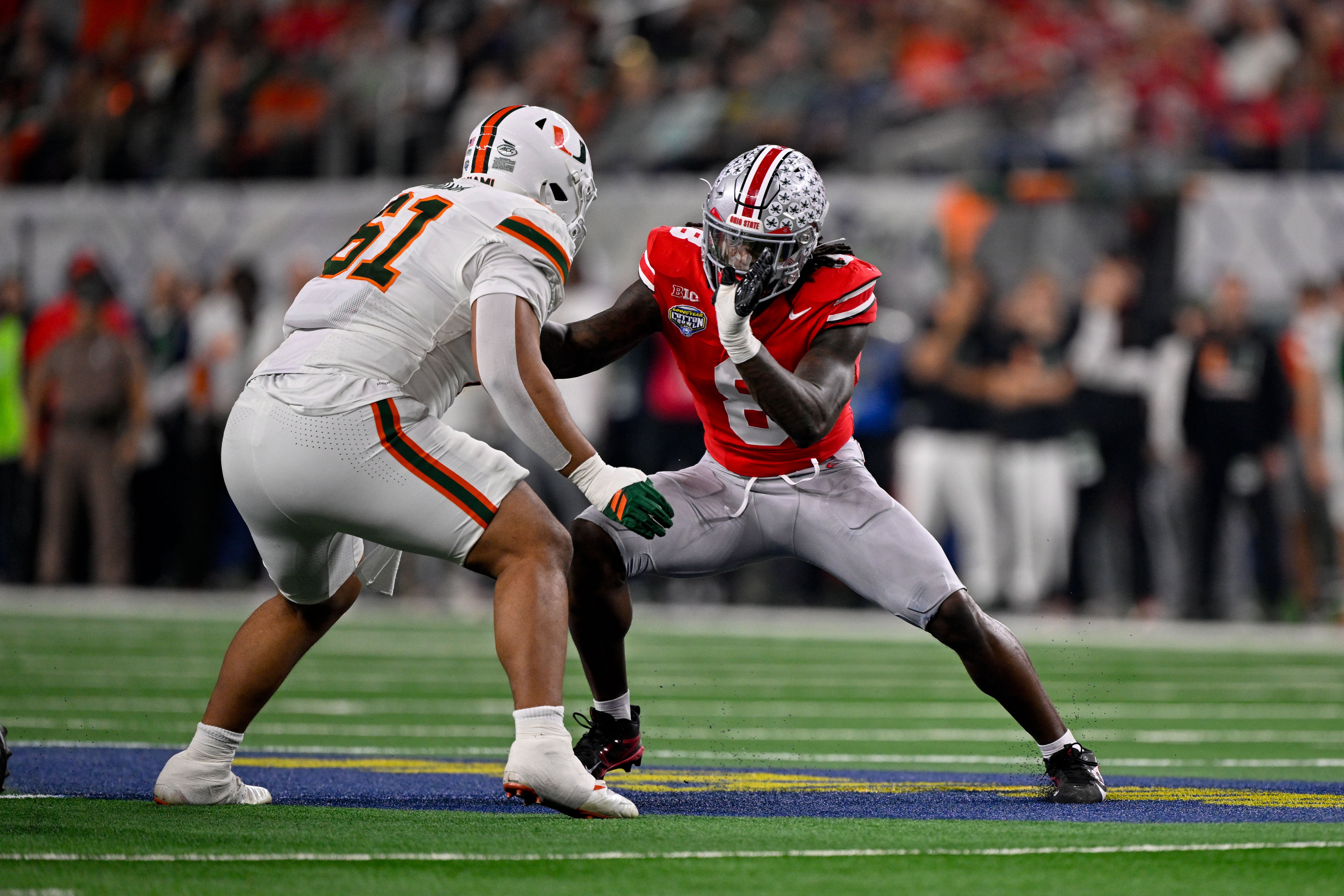 Dec 31, 2025; Arlington, TX, USA; Miami Hurricanes offensive lineman Francis Mauigoa (61) blocks Ohio State Buckeyes linebacker Arvell Reese (8) during the 2025 Cotton Bowl and quarterfinal game of the College Football Playoff at AT&T Stadium.