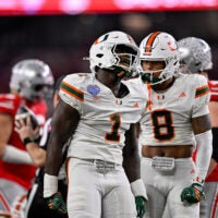 Dec 31, 2025; Arlington, TX, USA; Miami Hurricanes linebacker Mohamed Toure (1) and defensive back Jakobe Thomas (8) celebrates a defensive stop during the 2025 Cotton Bowl and quarterfinal game of the College Football Playoff at AT&T Stadium.