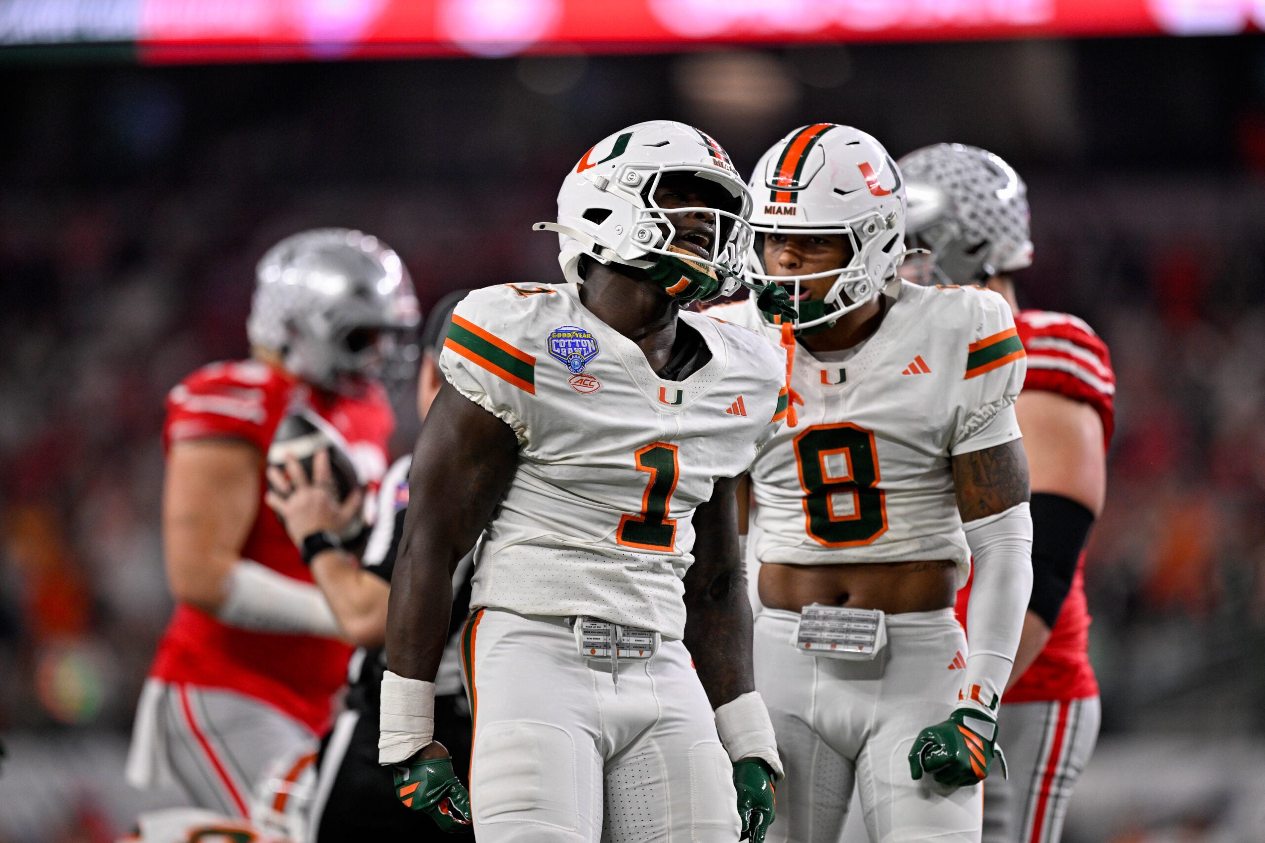Dec 31, 2025; Arlington, TX, USA; Miami Hurricanes linebacker Mohamed Toure (1) and defensive back Jakobe Thomas (8) celebrates a defensive stop during the 2025 Cotton Bowl and quarterfinal game of the College Football Playoff at AT&T Stadium.