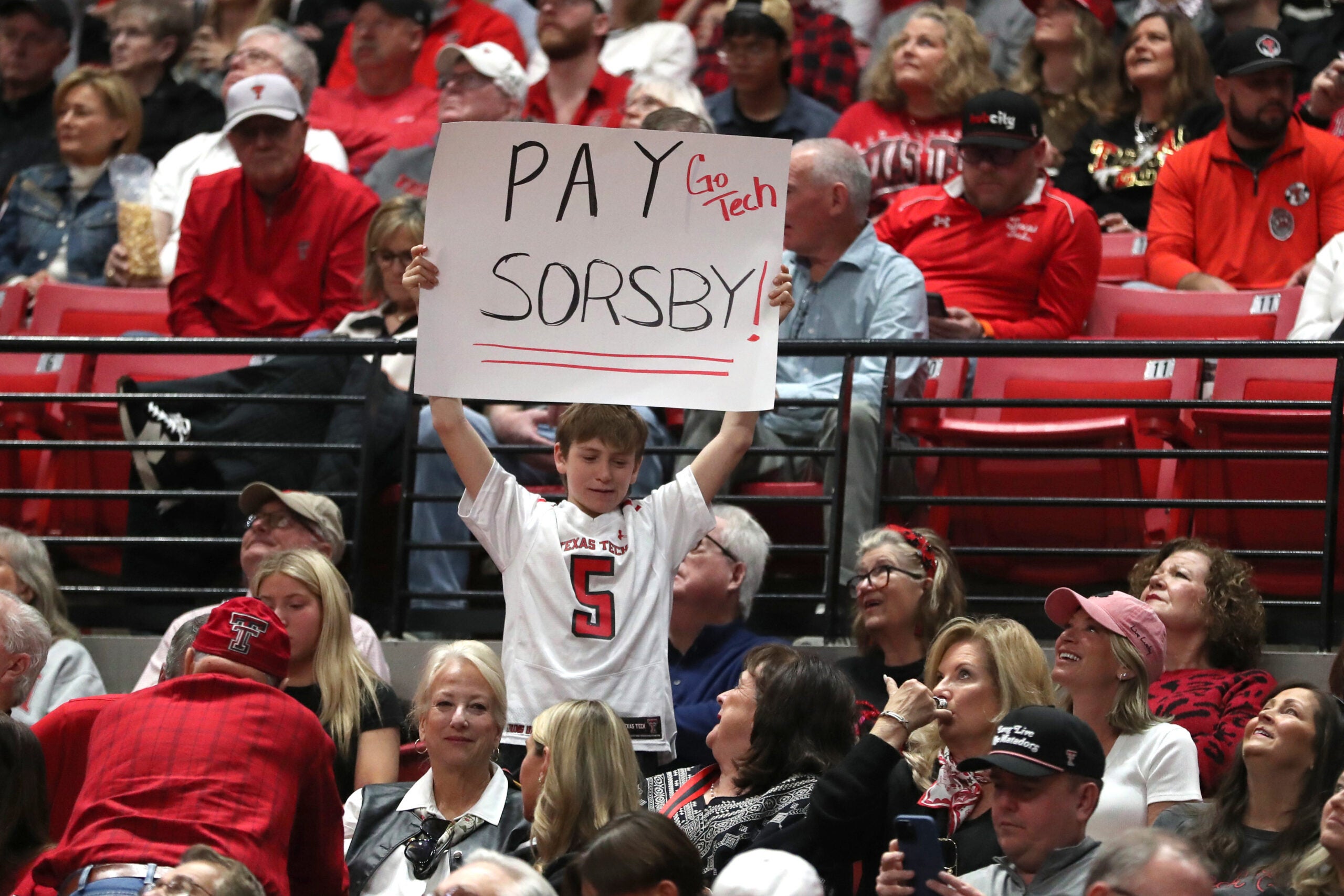 Jan 3, 2026; Lubbock, Texas, USA; A young Texas Tech Red Raiders fan shows his support for quarterback Brendan Sorsby in the second half of the basketball game against the Oklahoma State Cowboys at United Supermarkets Arena. Sorsby is currently in the NCAA football transfer portal. Mandatory Credit: Michael C. Johnson-Imagn Images