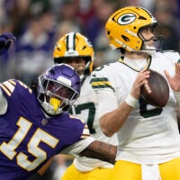 Jan 4, 2026; Minneapolis, Minnesota, USA; Minnesota Vikings linebacker Dallas Turner (15) pressures Green Bay Packers quarterback Clayton Tune (6) during the first quarter at U.S. Bank Stadium.