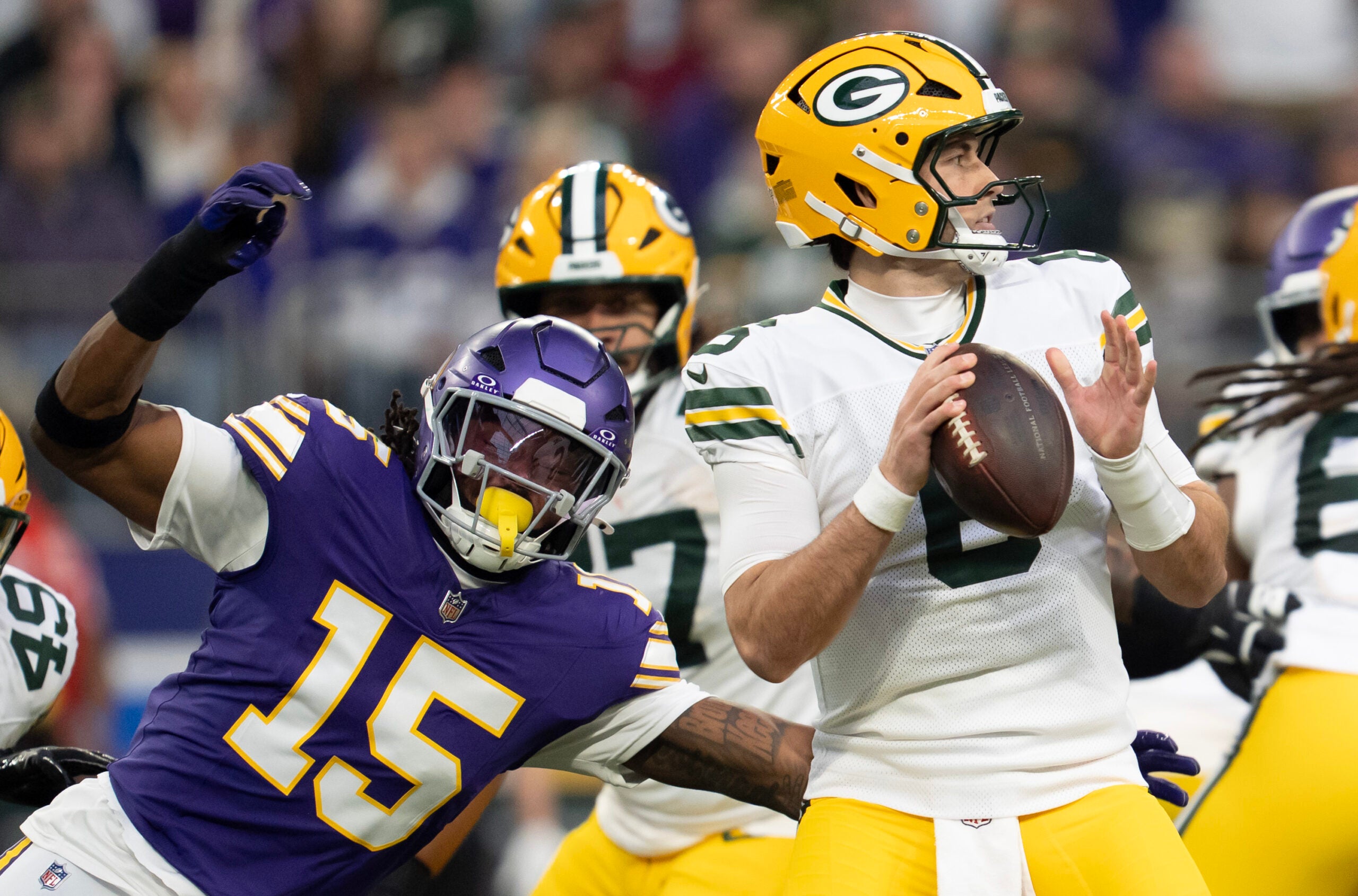 Jan 4, 2026; Minneapolis, Minnesota, USA; Minnesota Vikings linebacker Dallas Turner (15) pressures Green Bay Packers quarterback Clayton Tune (6) during the first quarter at U.S. Bank Stadium.