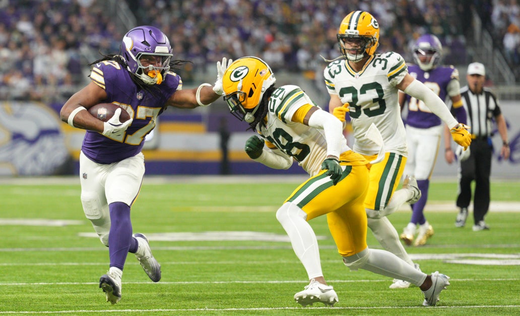Jan 4, 2026; Minneapolis, Minnesota, USA; Minnesota Vikings running back Jordan Mason (27) runs the ball against Green Bay Packers cornerback Trevon Diggs (28) during the second quarter at U.S. Bank Stadium.