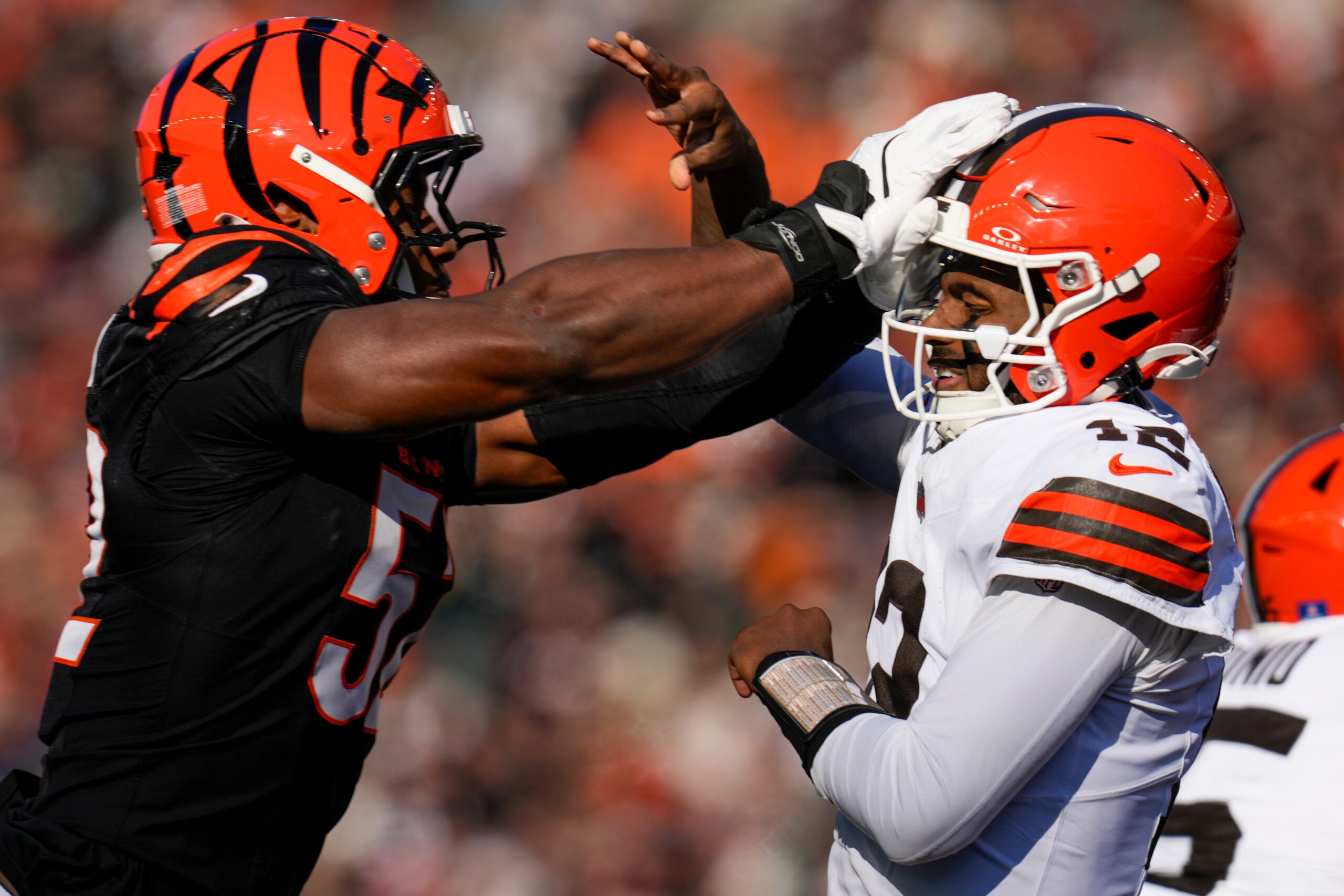 Cincinnati Bengals defensive end Cedric Johnson (52) gets his hands on Cleveland Browns quarterback Shedeur Sanders (12) as he throws in the second quarter of the NFL Week 18 game between the Cincinnati Bengals and the Cleveland Browns at Paycor Stadium in Downtown Cincinnati on Sunday, Jan. 4, 2026.