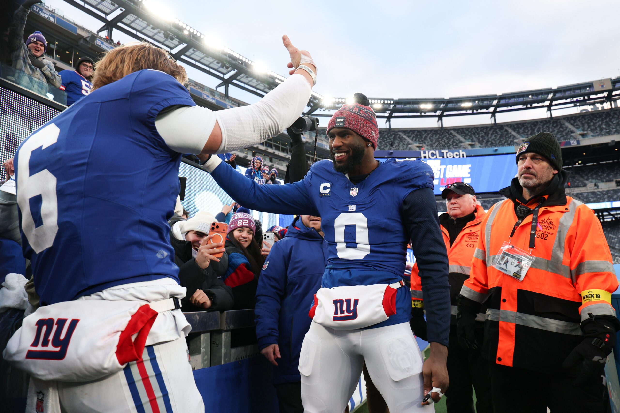 Jan 4, 2026; East Rutherford, New Jersey, USA; New York Giants linebacker Brian Burns (0) greets New York Giants quarterback Jaxson Dart (6) after the game against the Dallas Cowboys at MetLife Stadium.