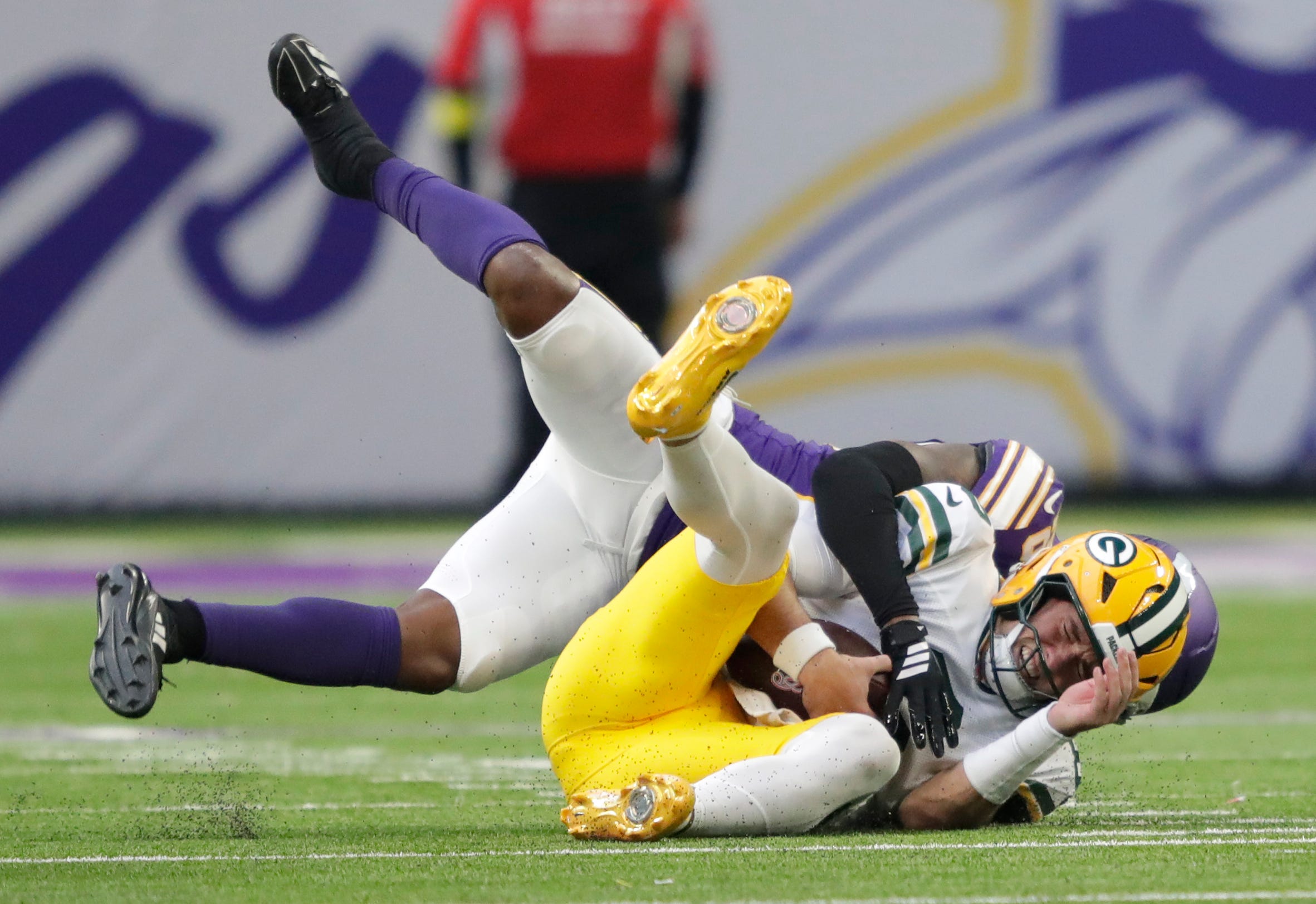 Green Bay Packers quarterback Clayton Tune (6) is sacked by Minnesota Vikings safety Theo Jackson (26) during their football game Sunday, January 4, 2026, at U.S. Bank Stadium in Minneapolis, Minnesota.