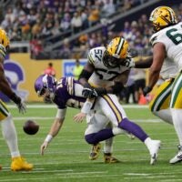 Green Bay Packers defensive end Brenton Cox Jr. (57) causes a fumble by Minnesota Vikings quarterback Max Brosmer (12) that is recovered by defensive end Barryn Sorrell (99) in the fourth quarter during their football game Sunday, January 4, 2026, at U.S. Bank Stadium in Minneapolis, Minnesota.