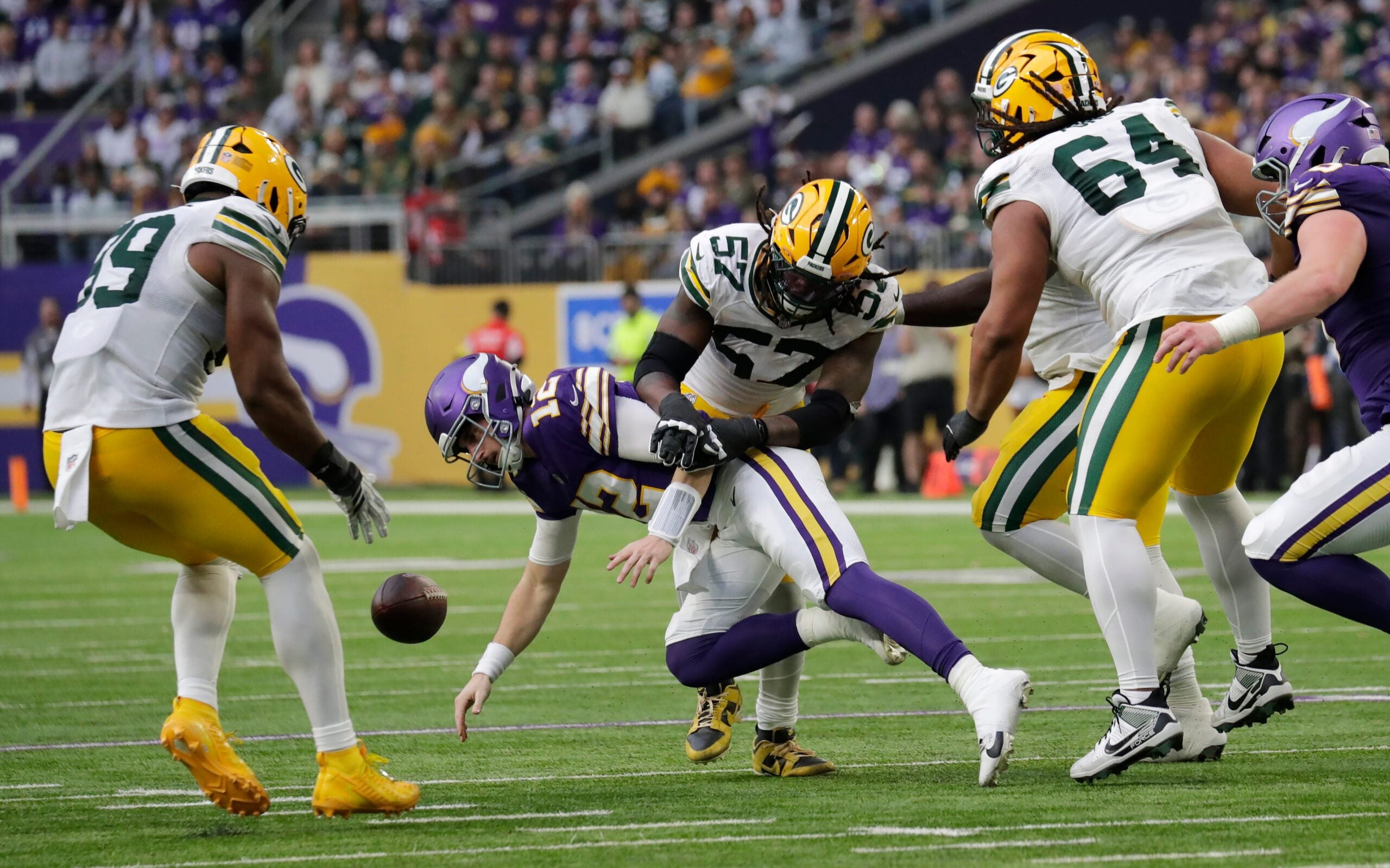 Green Bay Packers defensive end Brenton Cox Jr. (57) causes a fumble by Minnesota Vikings quarterback Max Brosmer (12) that is recovered by defensive end Barryn Sorrell (99) in the fourth quarter during their football game Sunday, January 4, 2026, at U.S. Bank Stadium in Minneapolis, Minnesota.