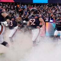 Jan 4, 2026; Chicago, Illinois, USA; Chicago Bears guard Joe Thuney (62) and center Drew Dalman (52) run onto the field before the game between the Chicago Bears and the Detroit Lions at Soldier Field.