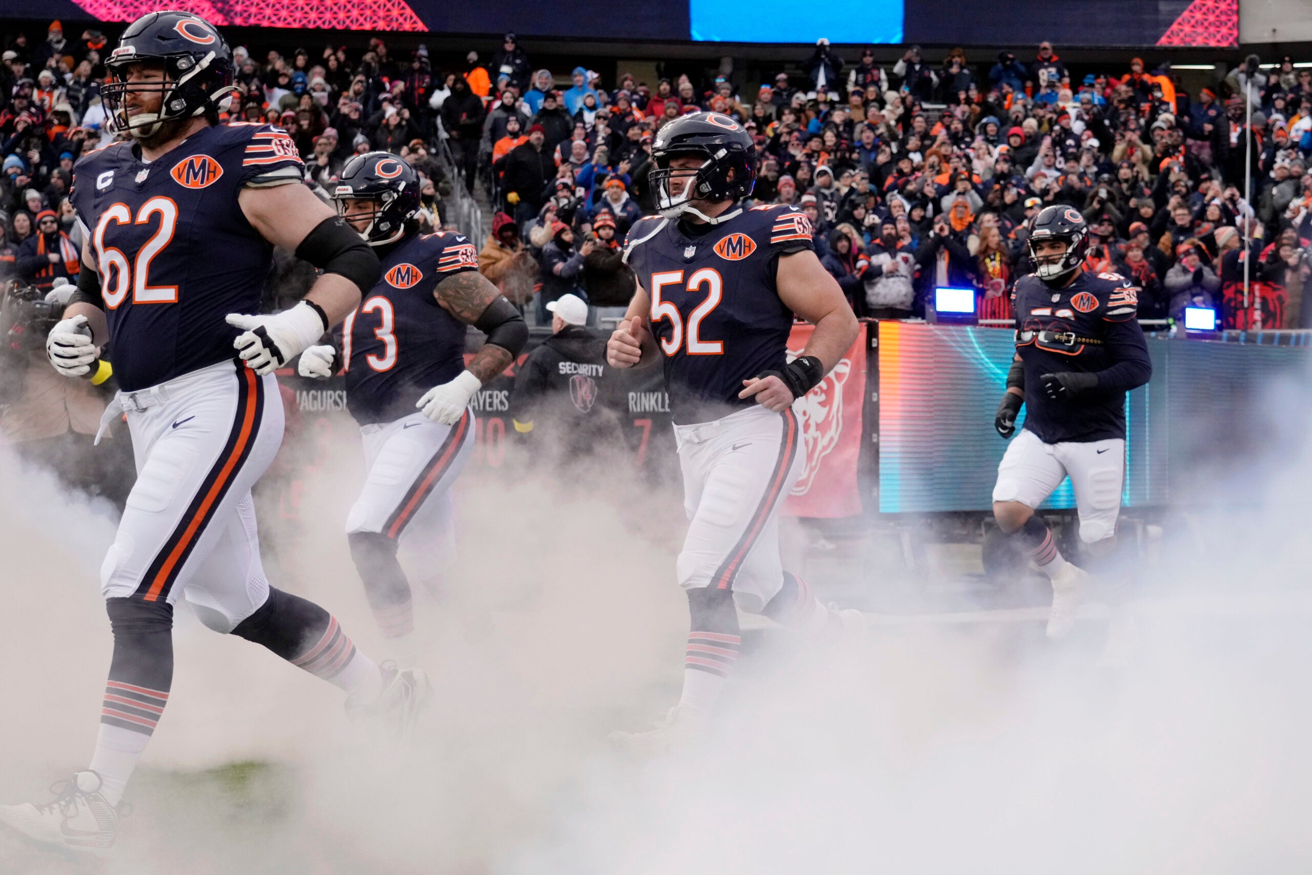 Jan 4, 2026; Chicago, Illinois, USA; Chicago Bears guard Joe Thuney (62) and center Drew Dalman (52) run onto the field before the game between the Chicago Bears and the Detroit Lions at Soldier Field.