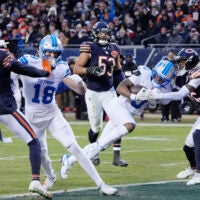 Jan 4, 2026; Chicago, Illinois, USA; Detroit Lions running back Jahmyr Gibbs (0) scores a touchdown against Chicago Bears cornerback Nahshon Wright (26) during the first half at Soldier Field.