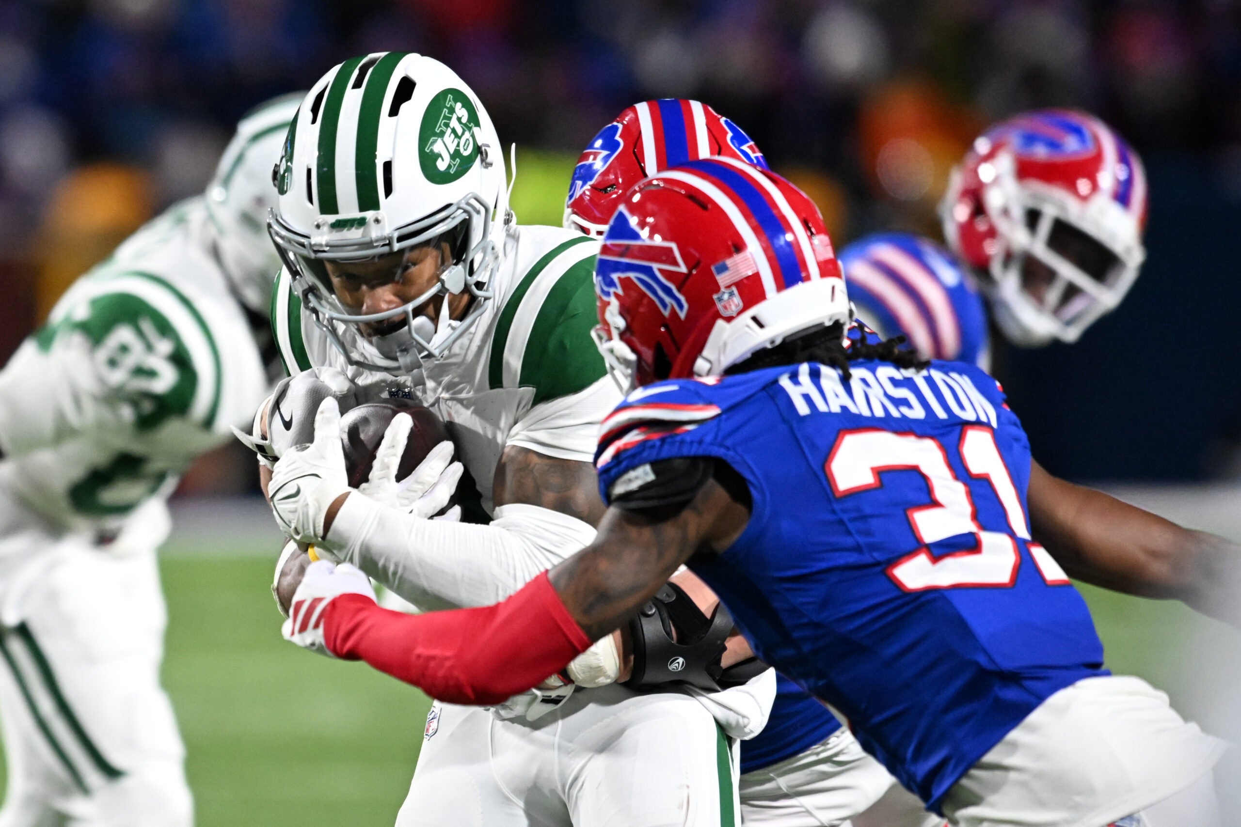 Jan 4, 2026; Orchard Park, New York, USA; New York Jets wide receiver John Metchie III (3) carries the ball defended by Buffalo Bills cornerback Maxwell Hairston (31) during the fourth quarter at Highmark Stadium.