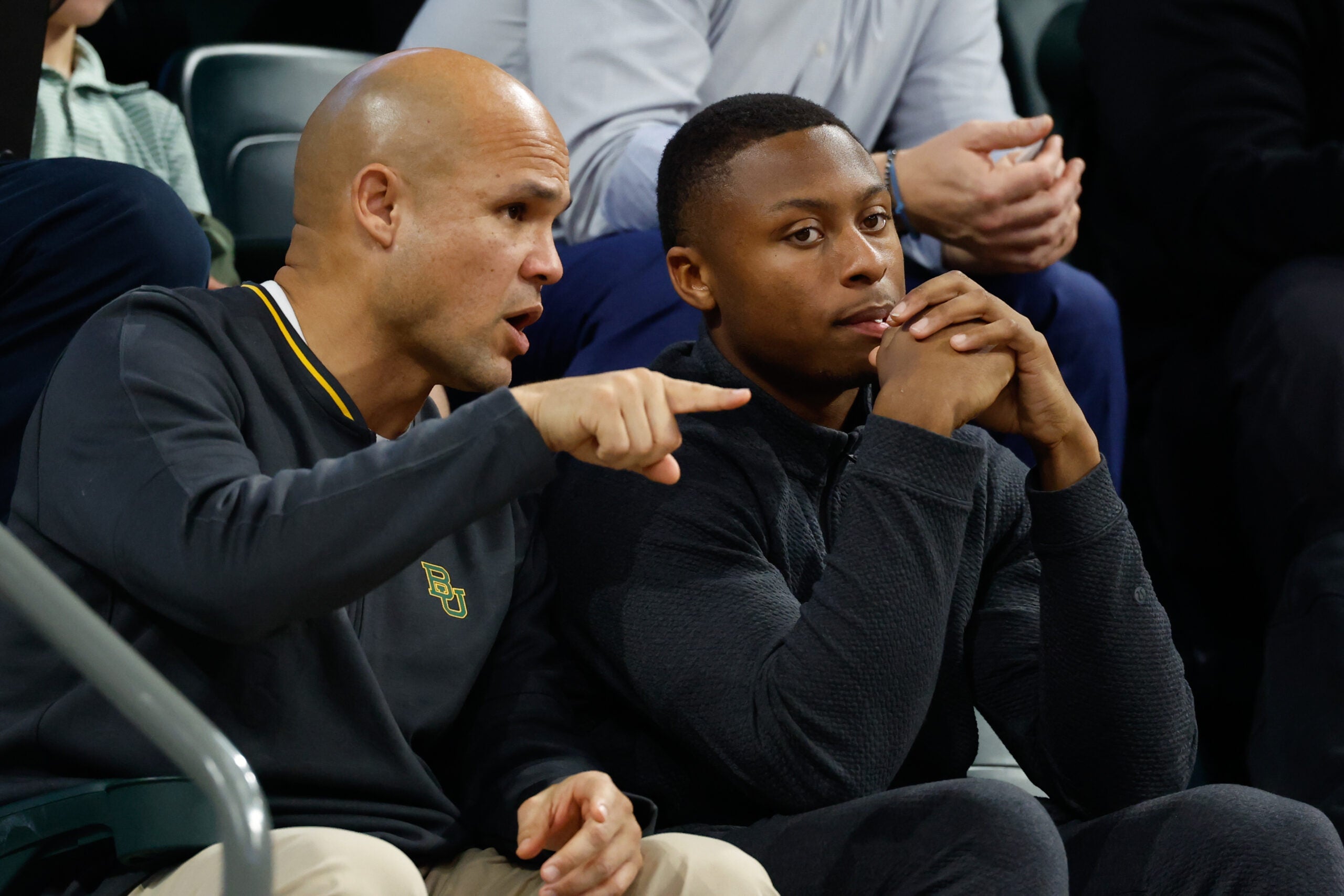 Jan 7, 2026; Waco, Texas, USA; DJ Lagway, a Florida quarterback currently in the transfer portal, sits with Baylor Bears football head coach Dave Aranda, left, during the first half of a game between the Baylor Bears and Iowa State Cyclones at Paul and Alejandra Foster Pavilion.