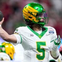 Oregon Ducks quarterback Dante Moore (5) draws back to pass Friday, Jan. 9, 2026, during the Peach Bowl and semifinal game of the College Football Playoff against the Indiana Hoosiers at Mercedes-Benz Stadium in Atlanta.