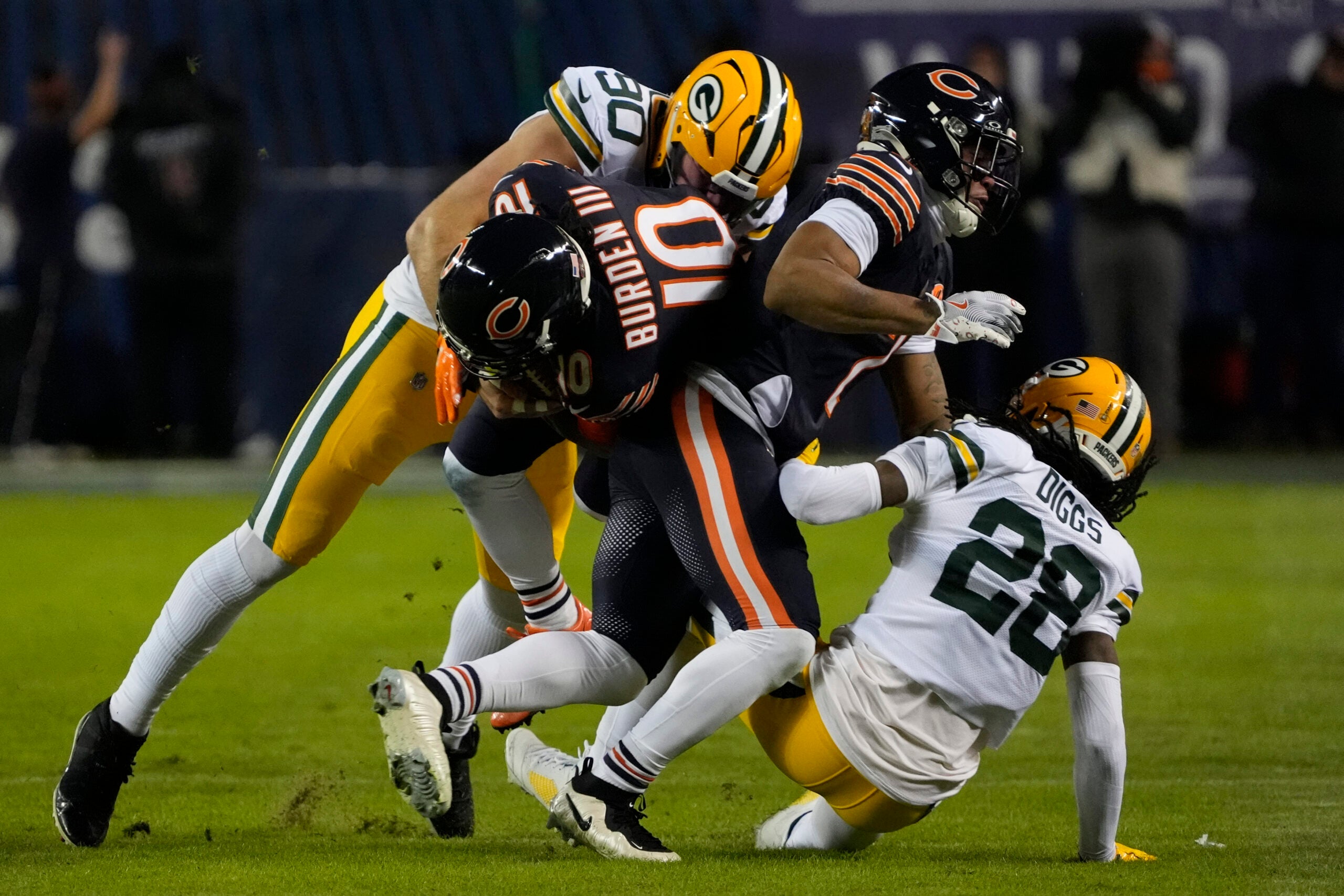 Jan 10, 2026; Chicago, IL, USA; Chicago Bears wide receiver Luther Burden III (10) is tackled by Green Bay Packers defensive end Lukas van Ness (90) after a reception during the first half of an NFC Wild Card Round game at Soldier Field.