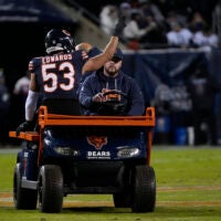Jan 10, 2026; Chicago, IL, USA; Chicago Bears linebacker T.J. Edwards (53) waves to the crowd as he is carted off the field with an apparent injury during the first half of an NFC Wild Card Round game against the Green Bay Packers at Soldier Field.