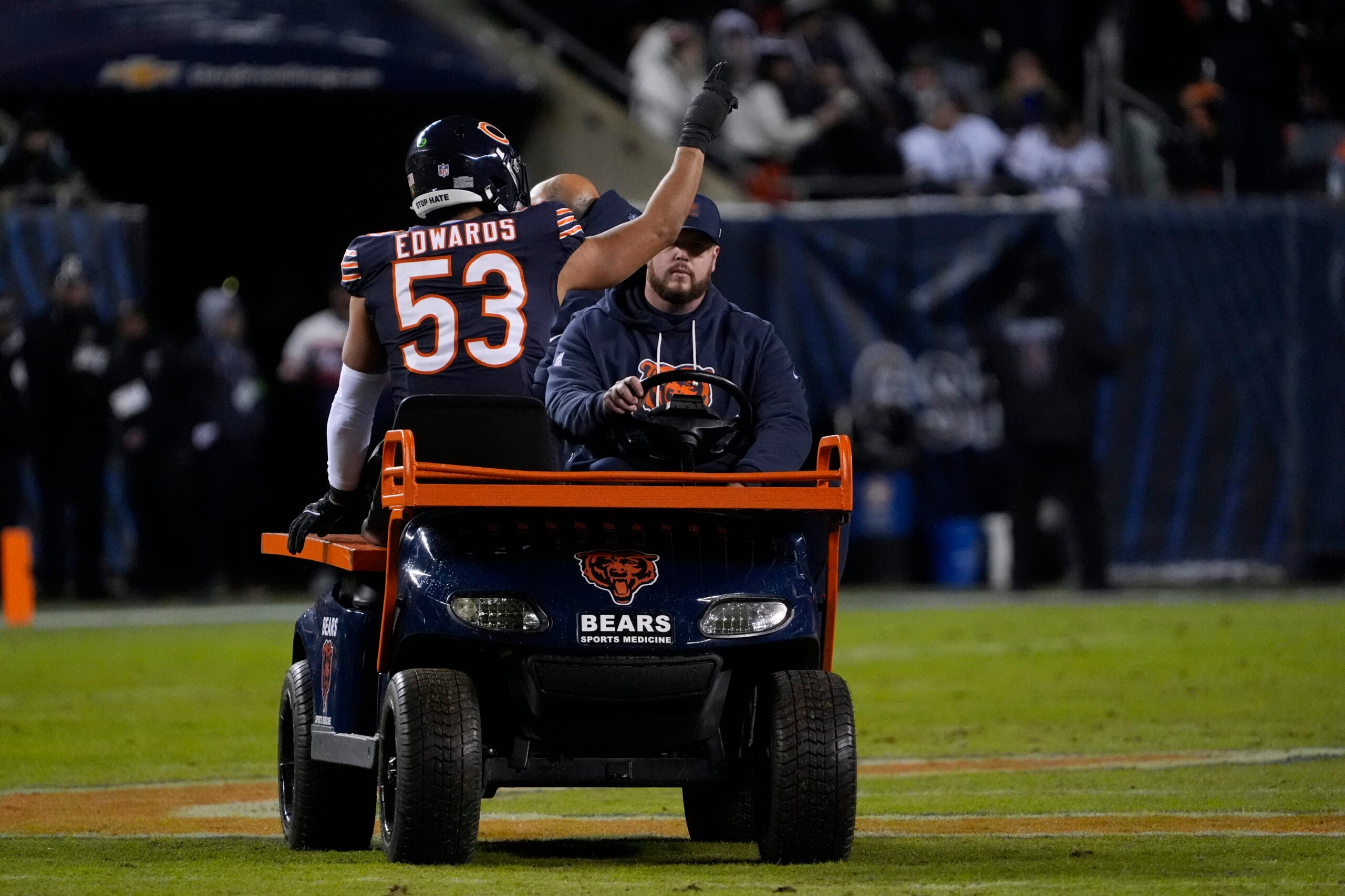Jan 10, 2026; Chicago, IL, USA; Chicago Bears linebacker T.J. Edwards (53) waves to the crowd as he is carted off the field with an apparent injury during the first half of an NFC Wild Card Round game against the Green Bay Packers at Soldier Field.