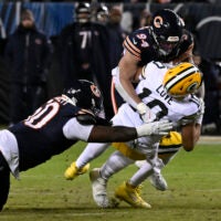 Jan 10, 2026; Chicago, IL, USA; Green Bay Packers quarterback Jordan Love (10) is sacked by. Chicago Bears defensive end Austin Booker (94) during the first half of an NFC Wild Card Round game at Soldier Field.