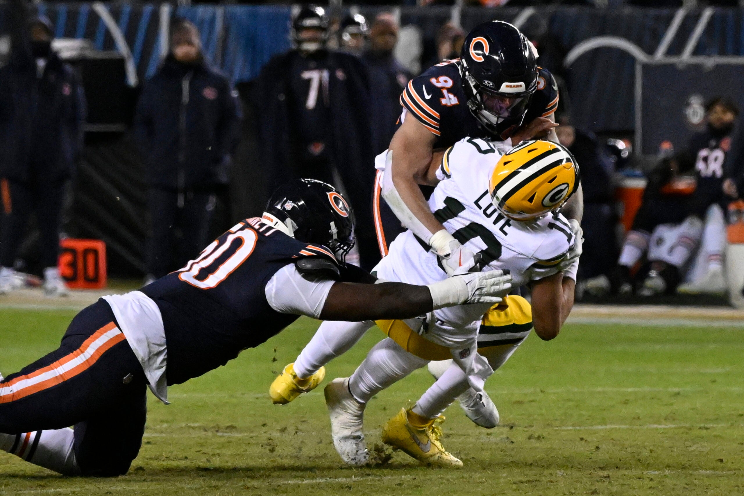 Jan 10, 2026; Chicago, IL, USA; Green Bay Packers quarterback Jordan Love (10) is sacked by. Chicago Bears defensive end Austin Booker (94) during the first half of an NFC Wild Card Round game at Soldier Field.