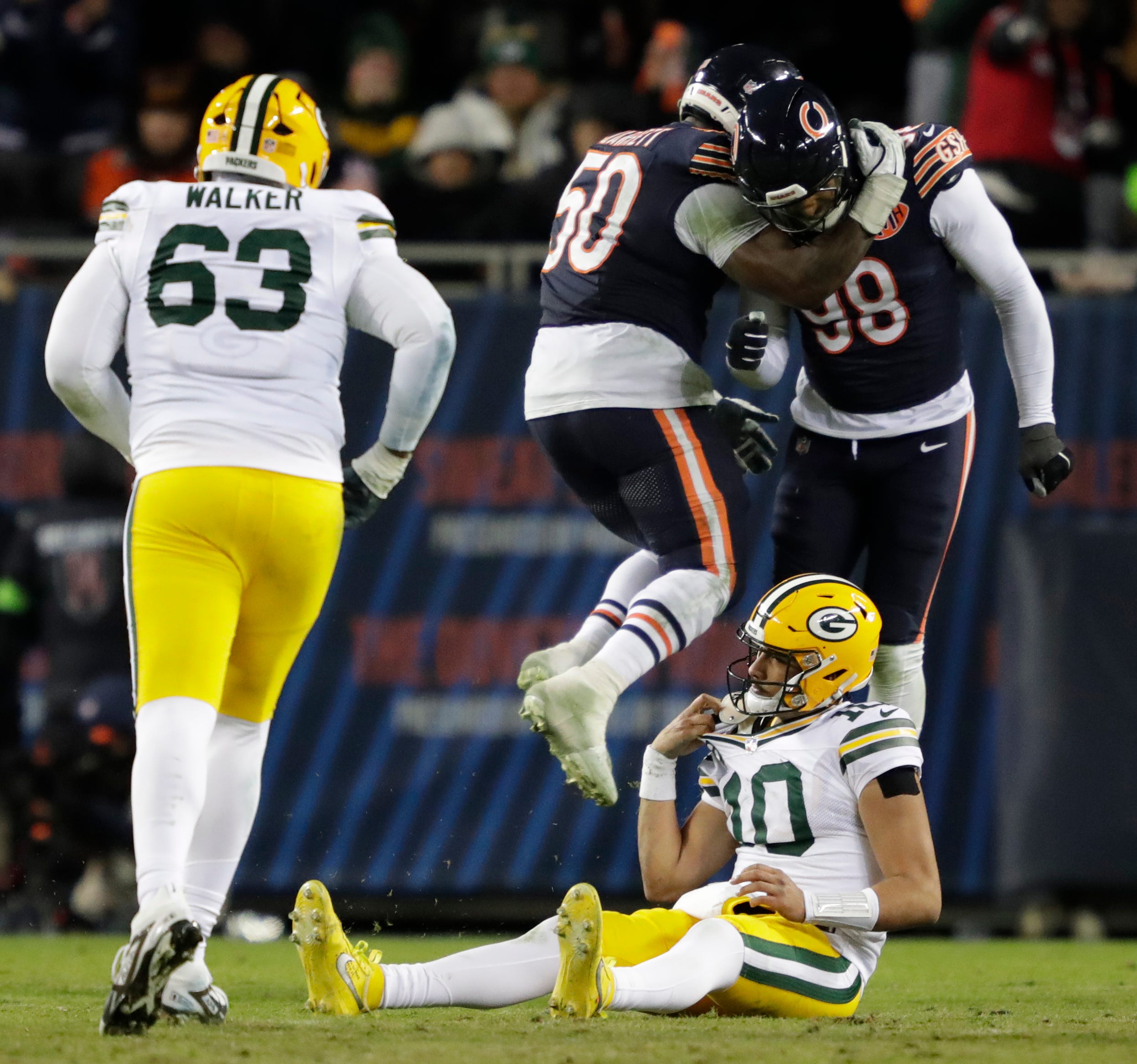 Chicago Bears defensive end Grady Jarrett (50) and defensive end Montez Sweat (98) celebrates forcing an incomplete pass by Green Bay Packers quarterback Jordan Love (10) in the fourth quarter during their wild-card playoff football game Saturday, January 10, 2026, at Soldier Field in Chicago, Illinois.