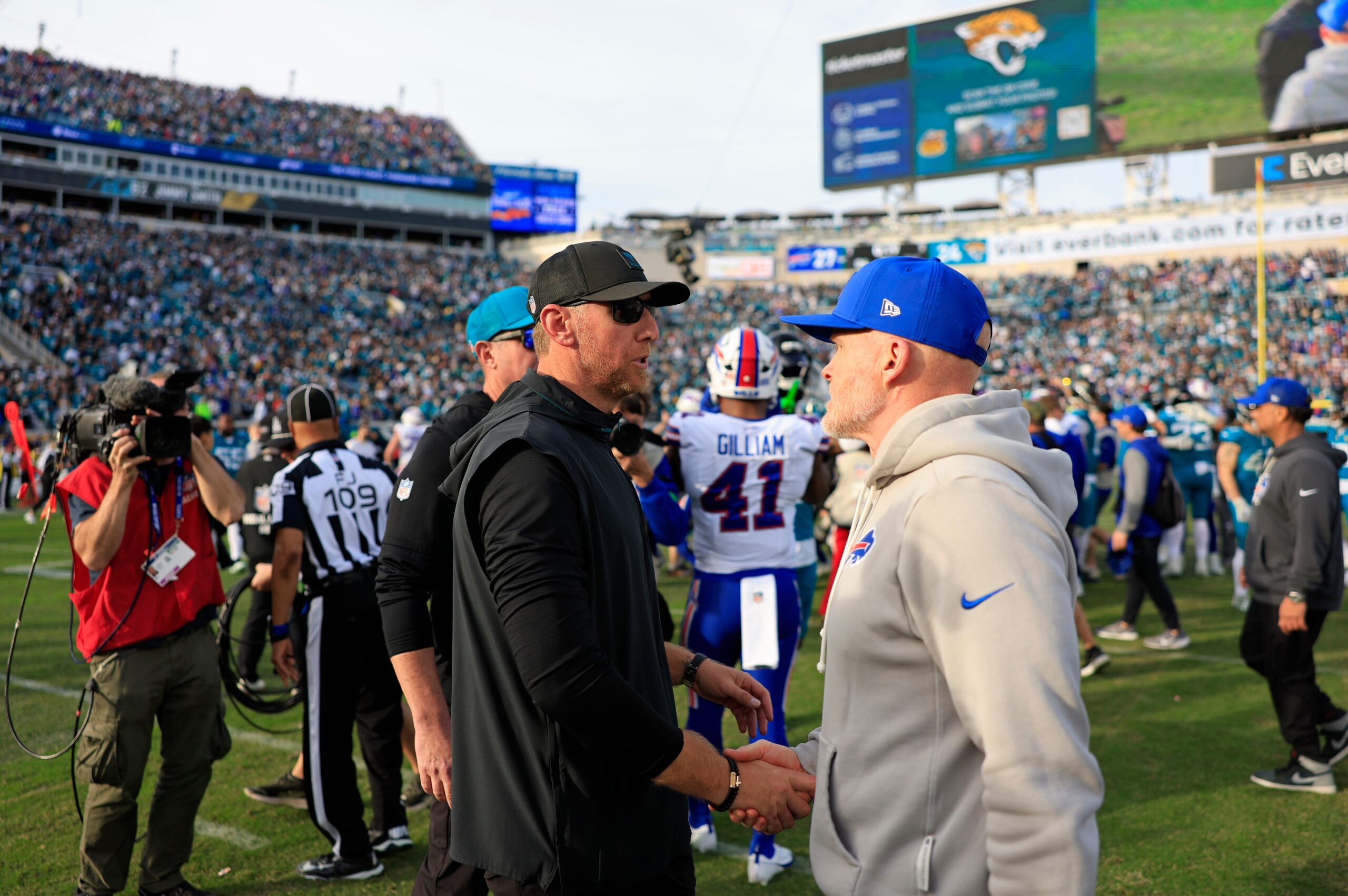Jacksonville Jaguars head coach Liam Coen, left, greets Buffalo Bills head coach Sean McDermott after the game of an NFL football AFC Wild Card playoff matchup, Sunday, Jan. 11, 2026, in Jacksonville, Fla. The Bills defeated the Jaguars 27-24.