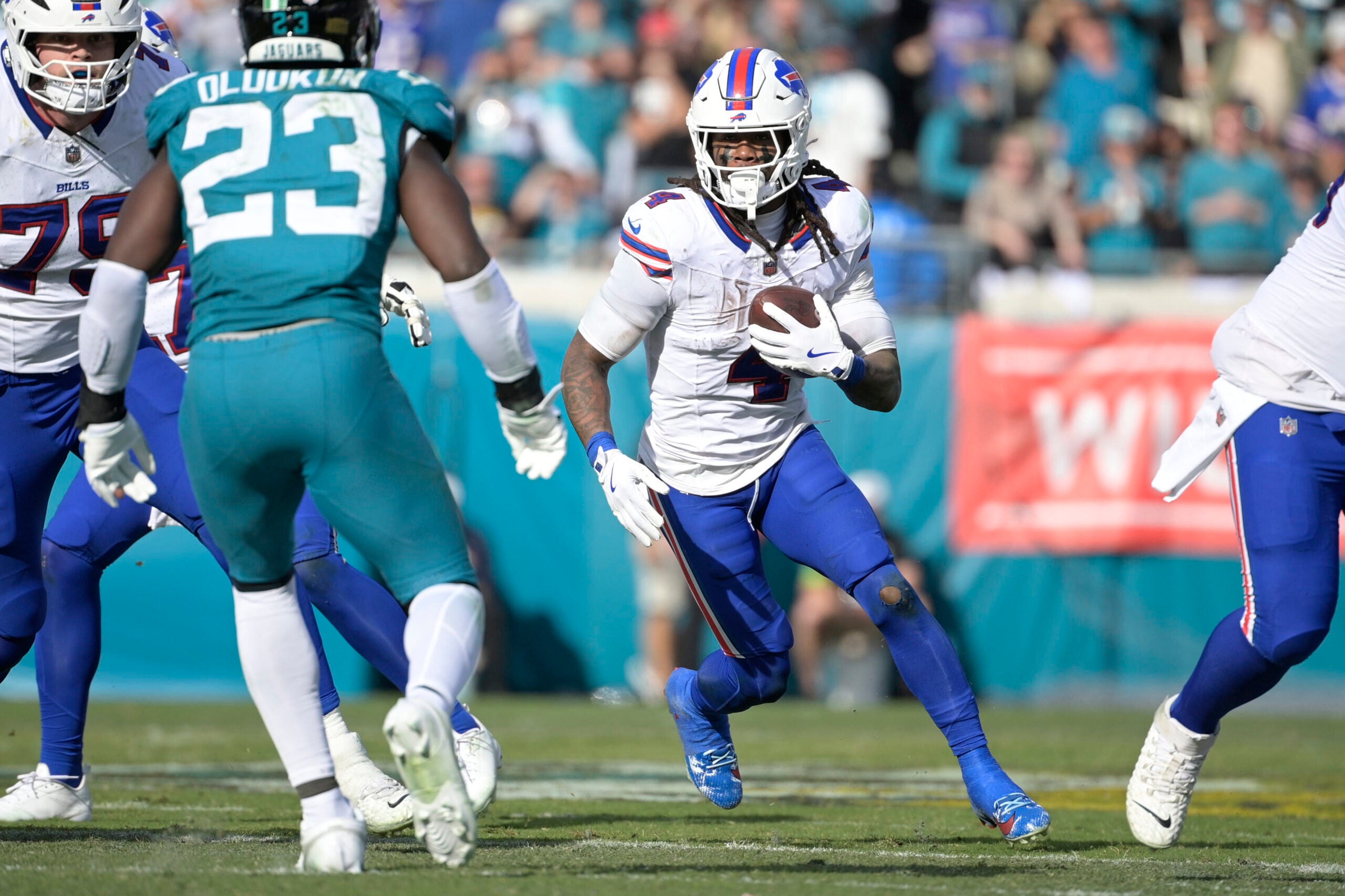 Jan 11, 2026; Jacksonville, FL, USA; Buffalo Bills running back James Cook III (4) carries the ball during the second half against the Jacksonville Jaguars in an AFC Wild Card Round game at EverBank Stadium.