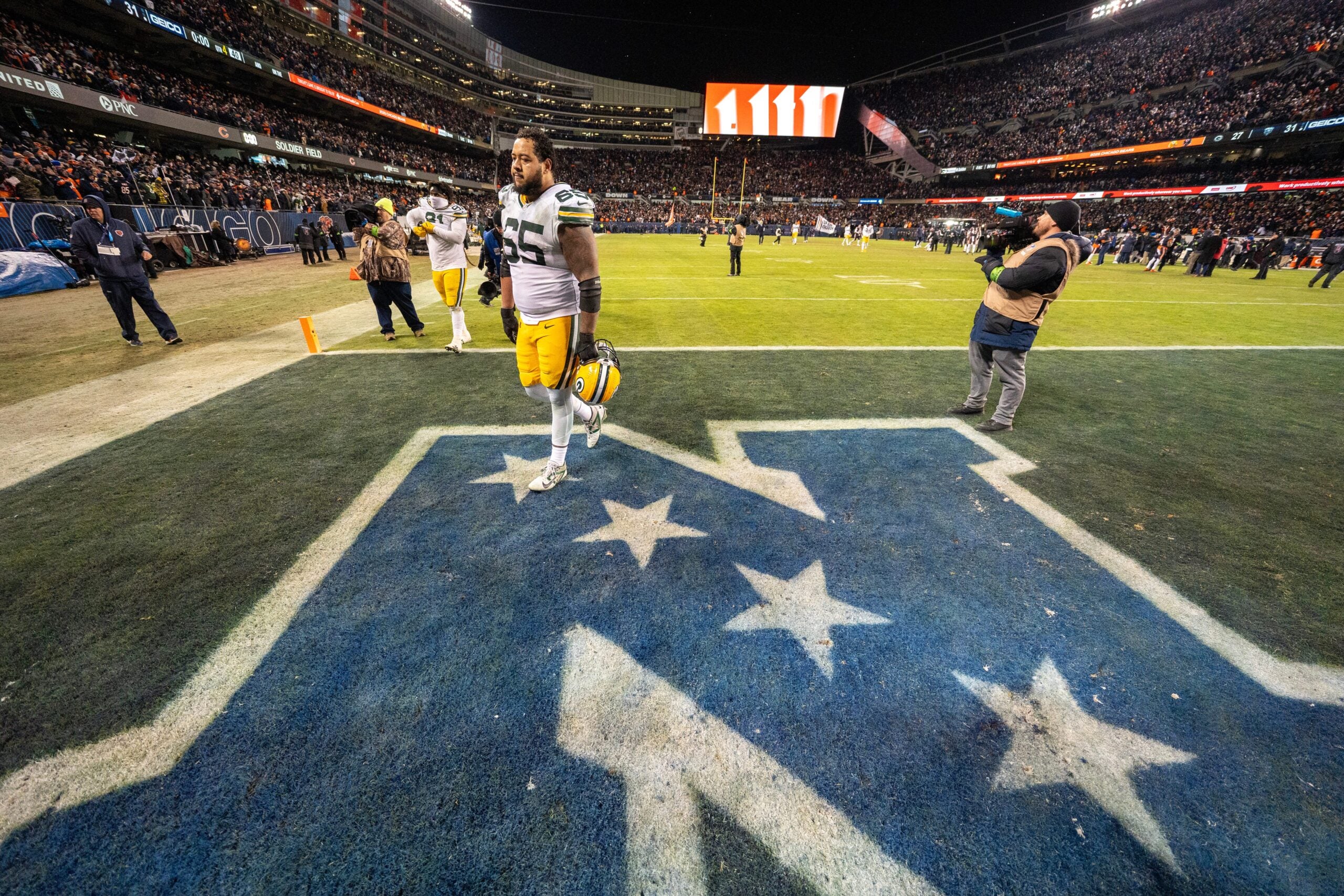 Green Bay Packers guard Aaron Banks (65) walks off the field after their wild card playoff game Saturday, January 10, 2026 at Soldier Field in Chicago, Illinois. The Chicago Bears beat the Green Bay Packers 31-27.