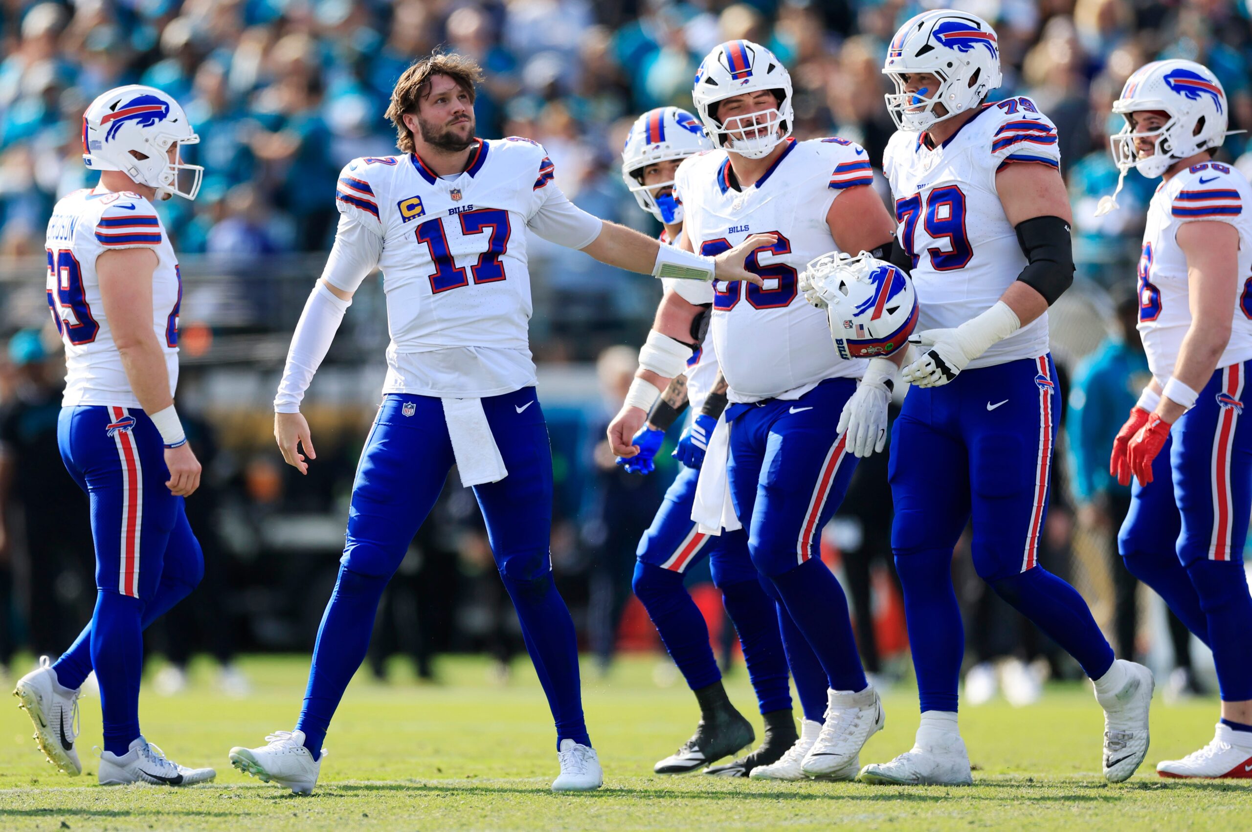 Buffalo Bills quarterback Josh Allen (17) collects his helmet from offensive tackle Spencer Brown (79) during the first quarter of an NFL football AFC Wild Card playoff matchup, Sunday, Jan. 11, 2026, in Jacksonville, Fla. The Bills defeated the Jaguars 27-24.