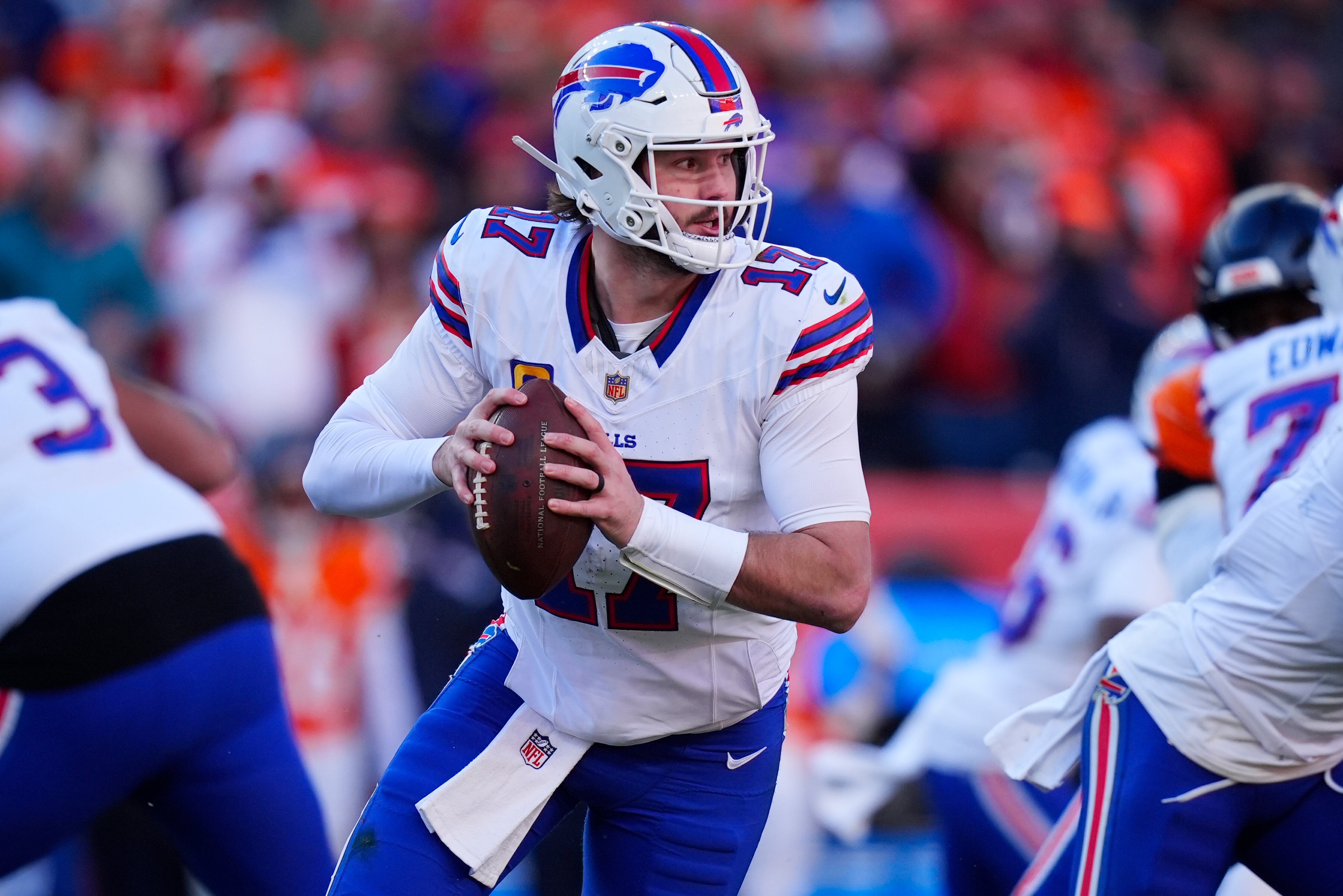 Jan 17, 2026; Denver, CO, USA; Buffalo Bills quarterback Josh Allen (17) rolls out during the second quarter of an AFC Divisional Round playoff game against the Denver Broncos at Empower Field at Mile High.