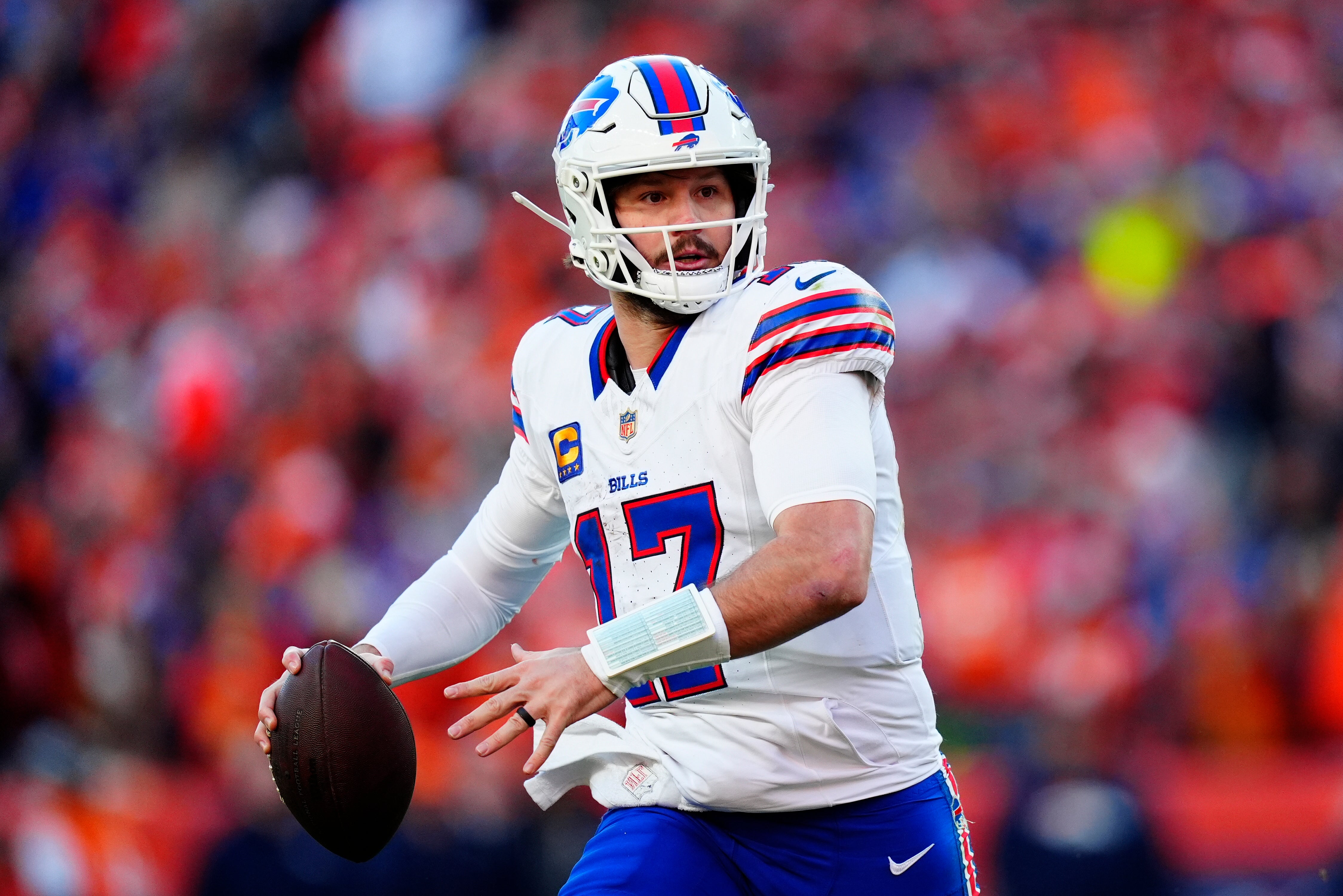 Jan 17, 2026; Denver, CO, USA; Buffalo Bills quarterback Josh Allen (17) rolls out during the second quarter of an AFC Divisional Round playoff game against the Denver Broncos at Empower Field at Mile High.