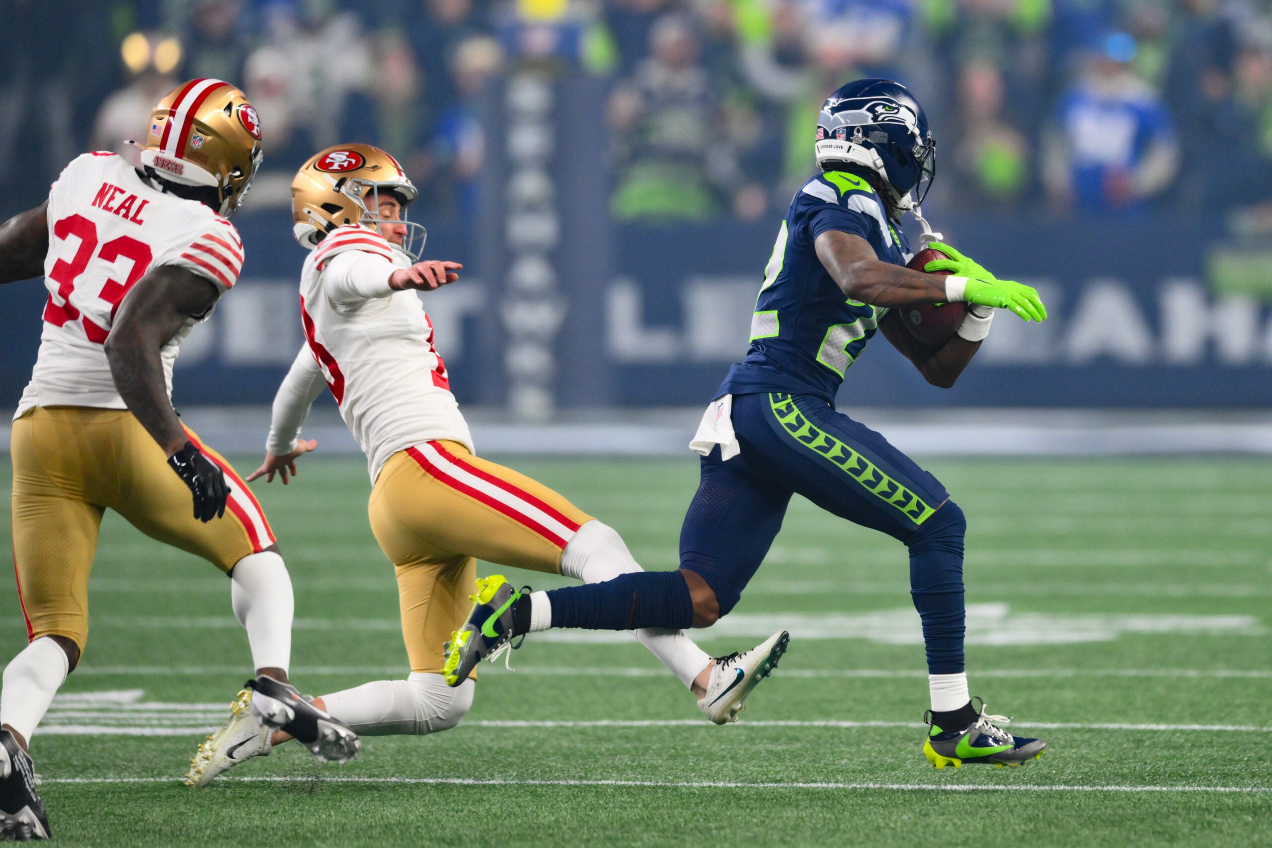 Jan 17, 2026; Seattle, WA, USA; Seattle Seahawks wide receiver Rashid Shaheed (22) returns a kickoff for a touchdown as San Francisco 49ers place kicker Eddy Pineiro (18) attempts to trip him up during the first half in an NFC Divisional Round game at Lumen Field.