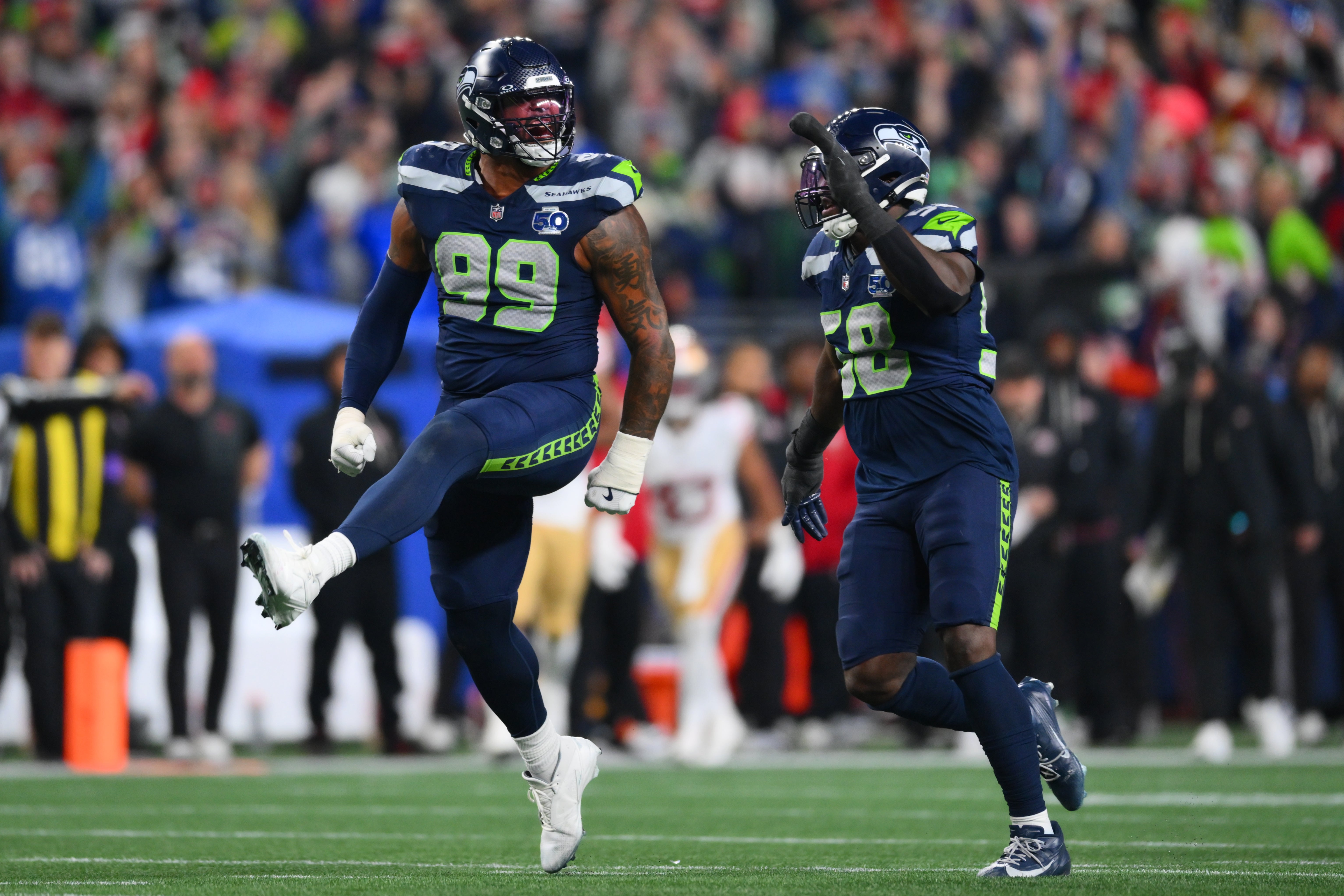 Jan 17, 2026; Seattle, WA, USA; Seattle Seahawks defensive end Leonard Williams (99) and linebacker Derick Hall (58) reacts after the sack of San Francisco 49ers quarterback Brock Purdy (13) during the second half in an NFC Divisional Round game at Lumen Field.