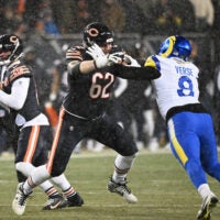 Jan 18, 2026; Chicago, IL, USA; Chicago Bears guard Joe Thuney (62) blocks for quarterback Caleb Williams (18) against Los Angeles Rams linebacker Jared Verse (8) during the first quarter of an NFC Divisional Round game at Soldier Field.