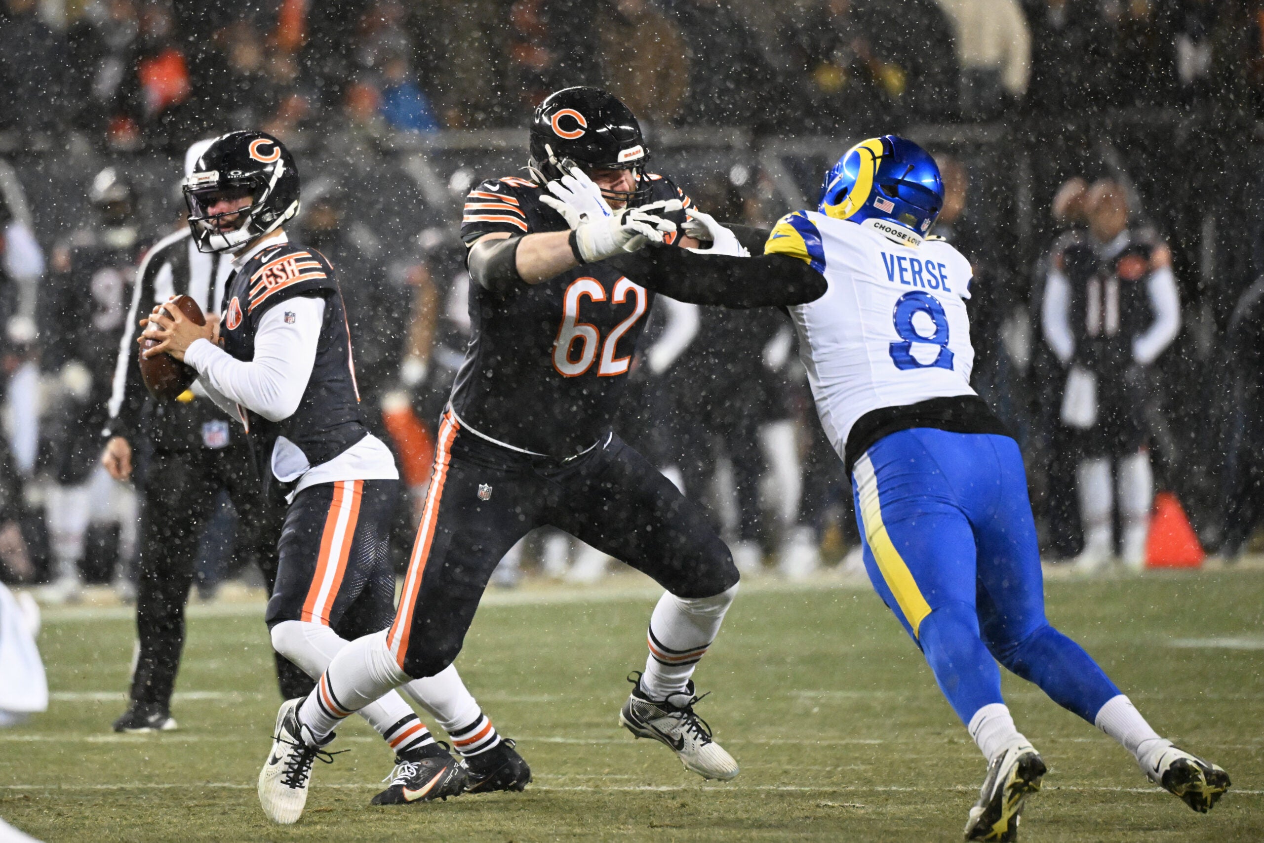 Jan 18, 2026; Chicago, IL, USA; Chicago Bears guard Joe Thuney (62) blocks for quarterback Caleb Williams (18) against Los Angeles Rams linebacker Jared Verse (8) during the first quarter of an NFC Divisional Round game at Soldier Field.