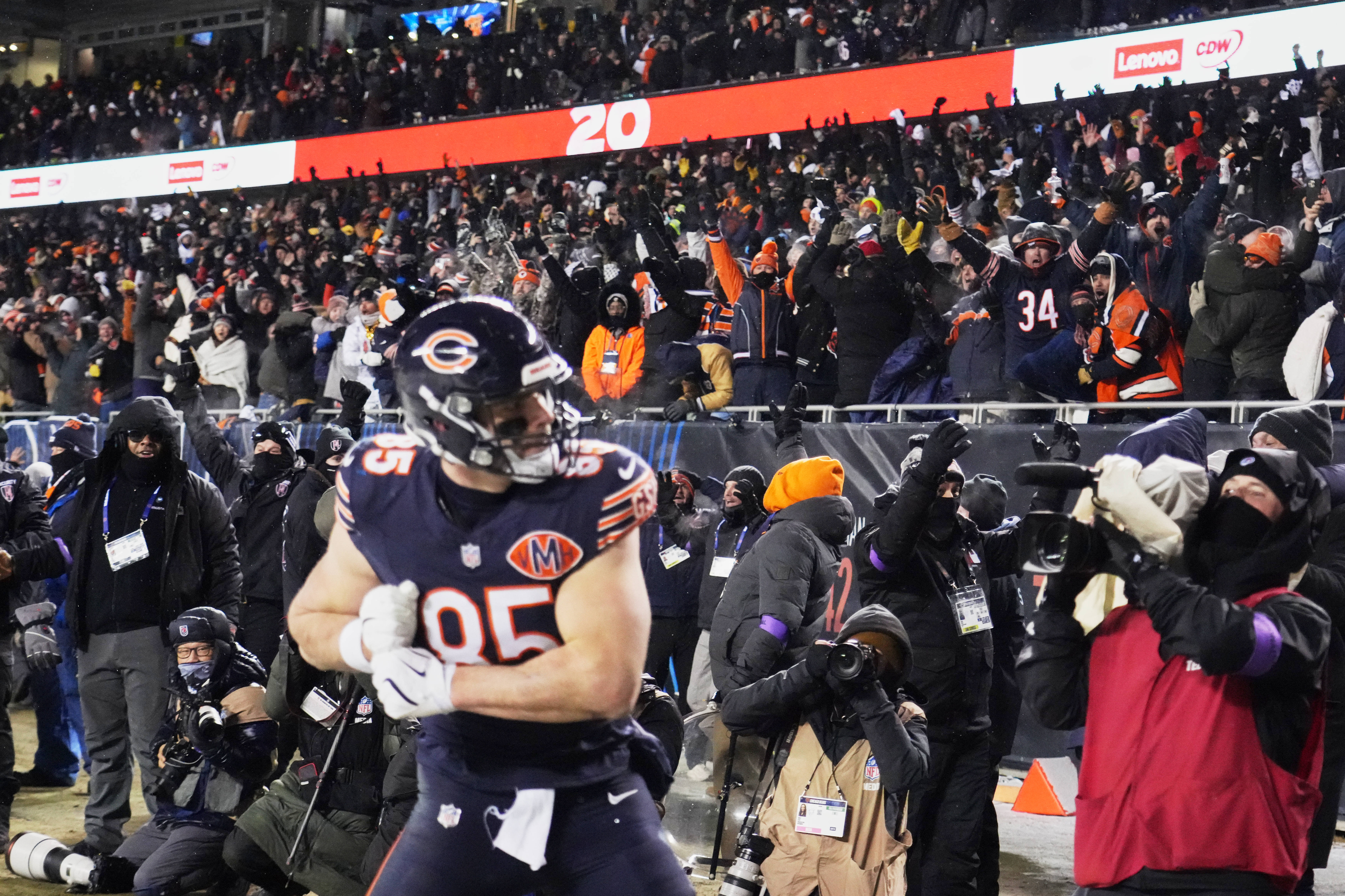 Fans cheer after a touchdown scored by Chicago Bears tight end Cole Kmet (85) against the Los Angeles Rams with eighteen seconds remaining in the fourth quarter of an NFC Divisional Round game at Soldier Field.