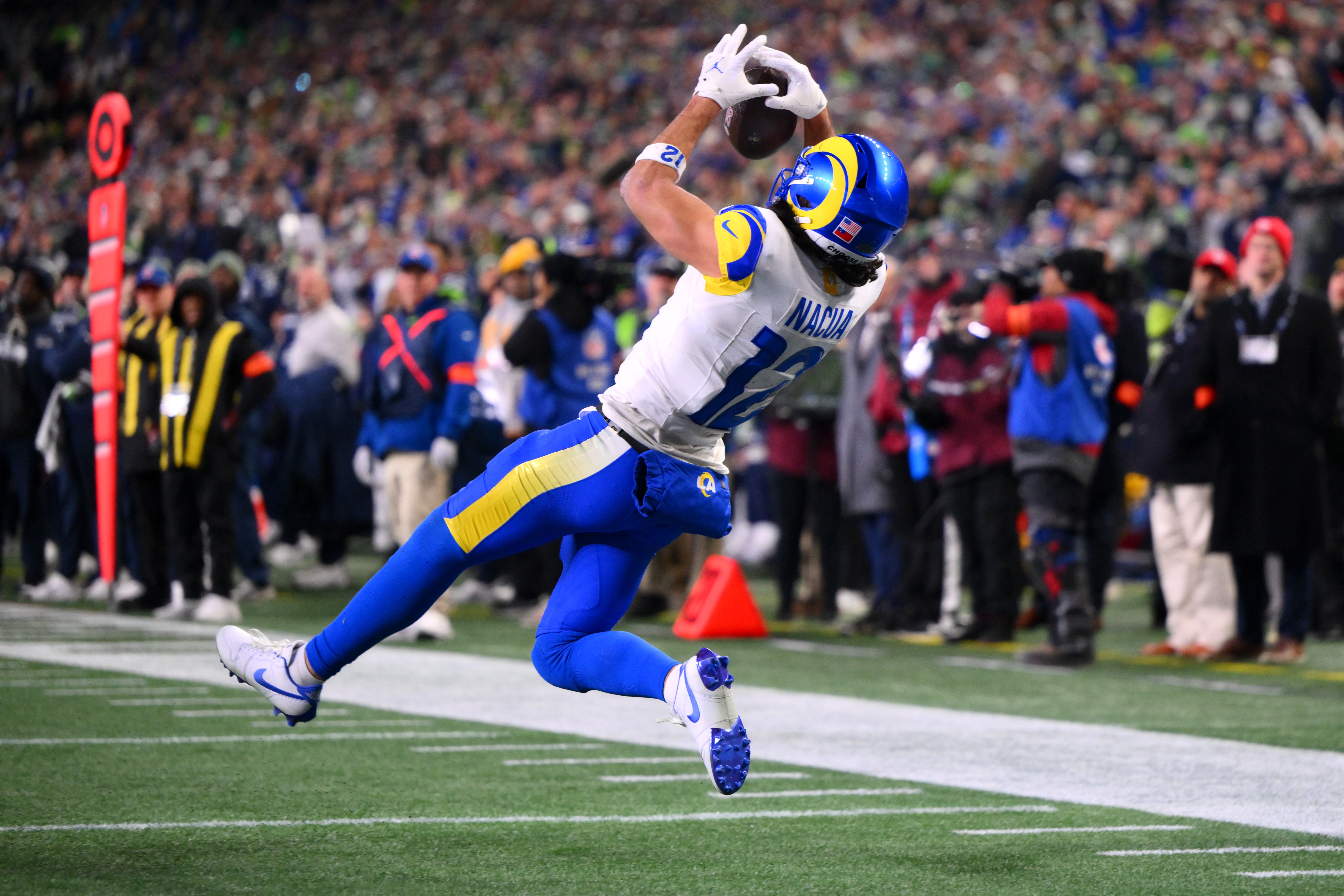 Jan 25, 2026; Seattle, WA, USA; Los Angeles Rams wide receiver Puka Nacua (12) scores a touchdown against the Seattle Seahawks during the second half in the 2026 NFC Championship Game at Lumen Field.
