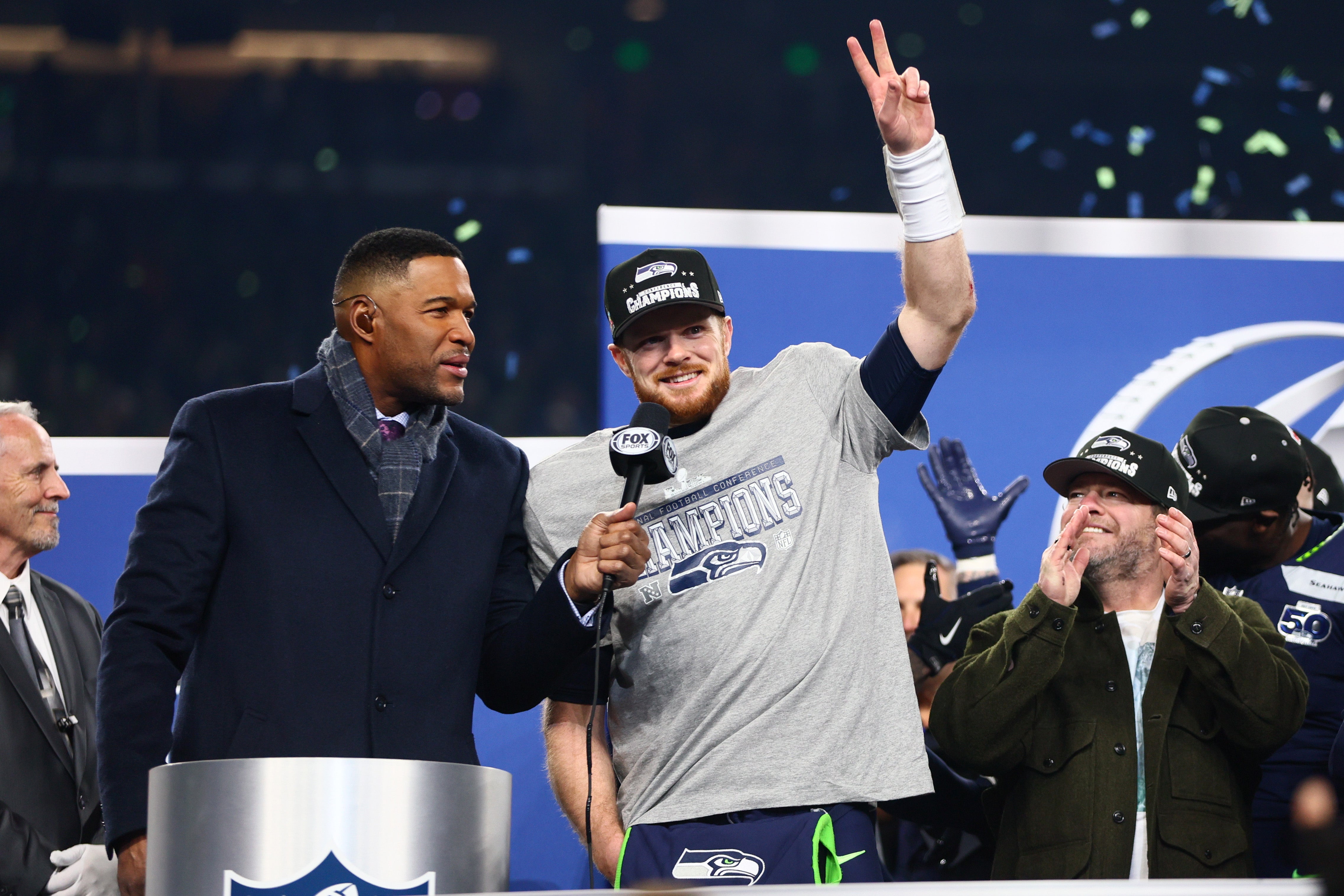 Jan 25, 2026; Seattle, WA, USA; Seattle Seahawks quarterback Sam Darnold (14) celebrates on the podium after defeating the Los Angeles Rams in the 2026 NFC Championship Game at Lumen Field.