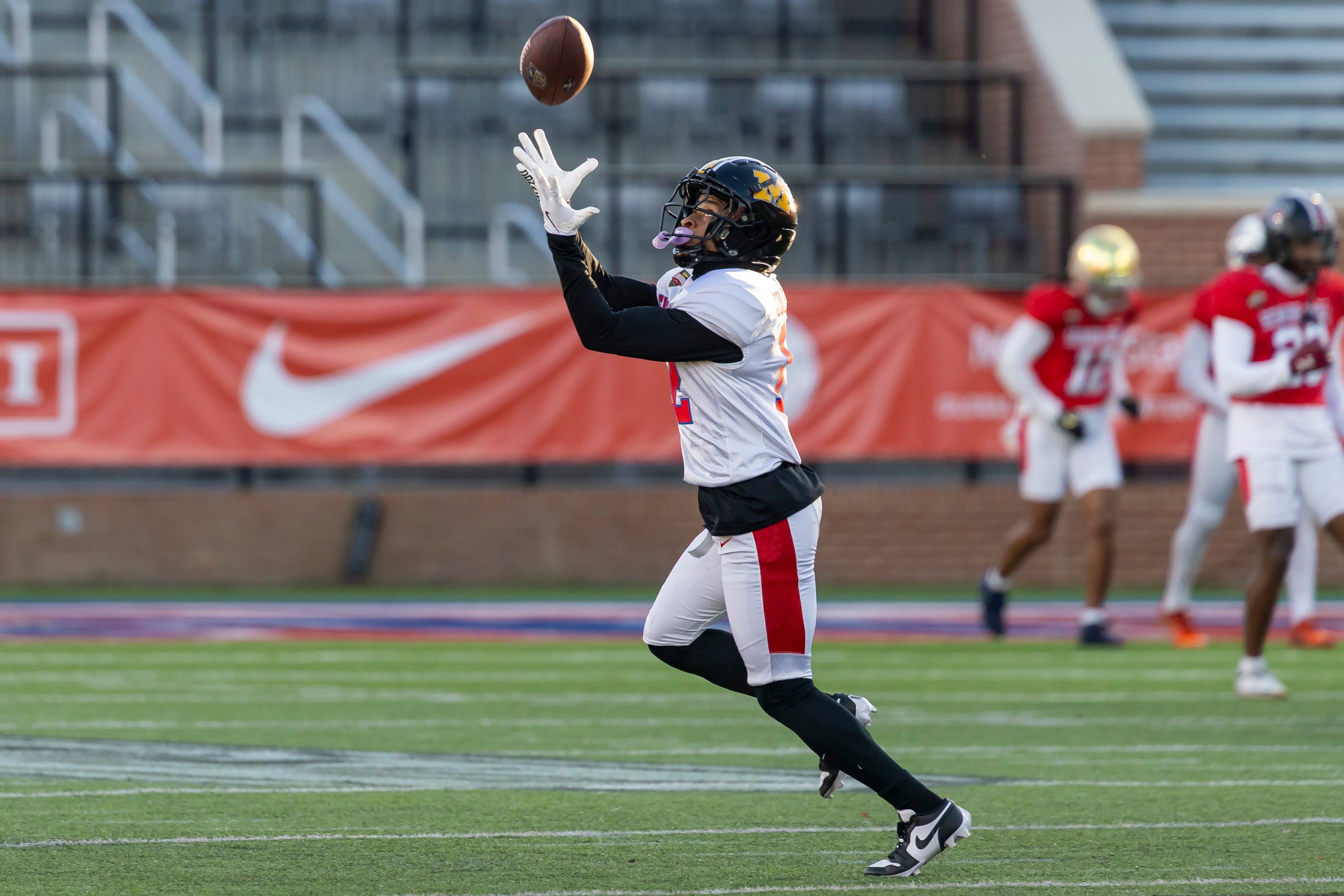 Jan 28, 2026; Mobile, AL, USA; American Team wide receiver Kevin Coleman Jr. (12) of Missouri makes a catch during American Senior Bowl practice at Hancock Whitney Stadium.